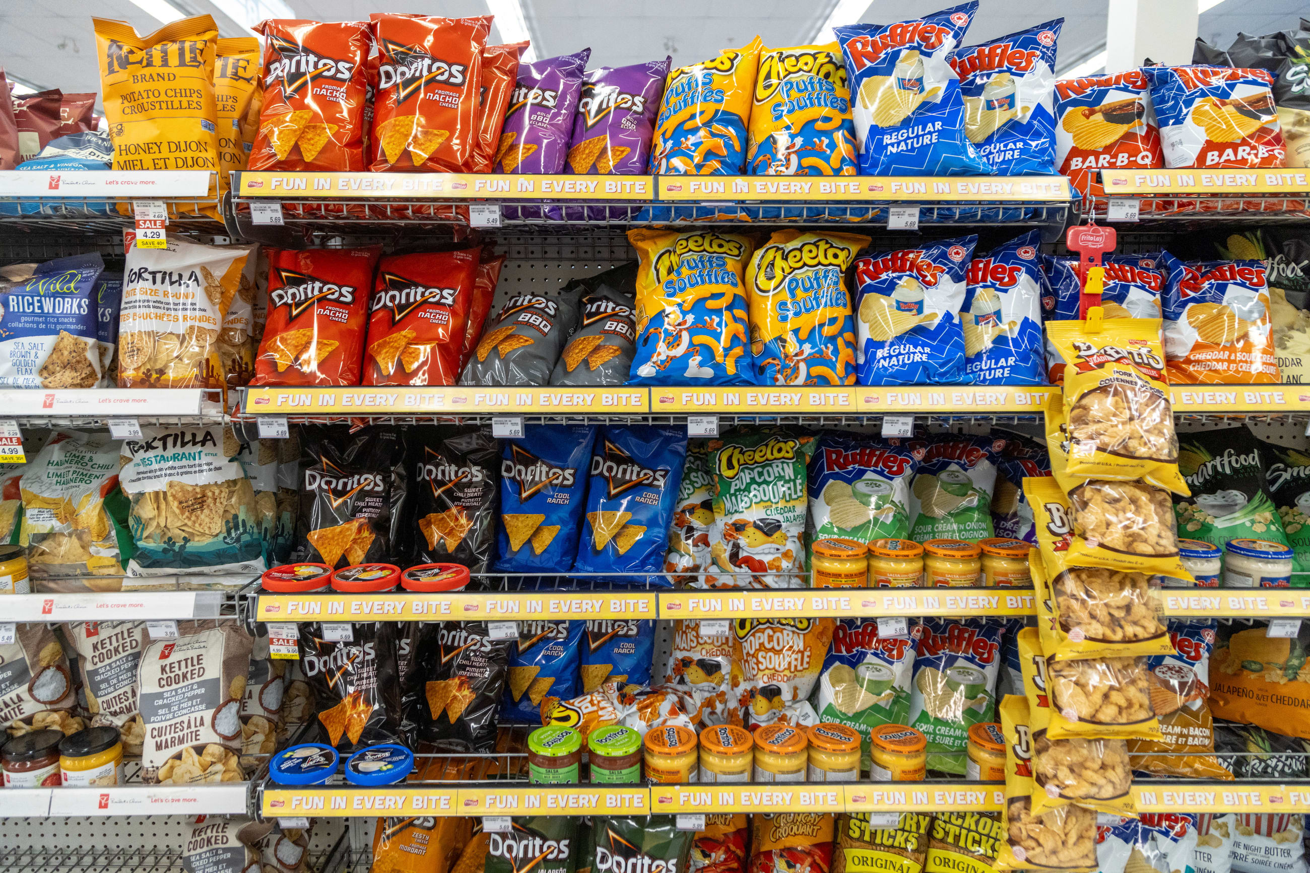 Bags of chips and other snack foods are displayed on shelves at a store, in Hamilton, Ontario, Canada, on January 28, 2025.