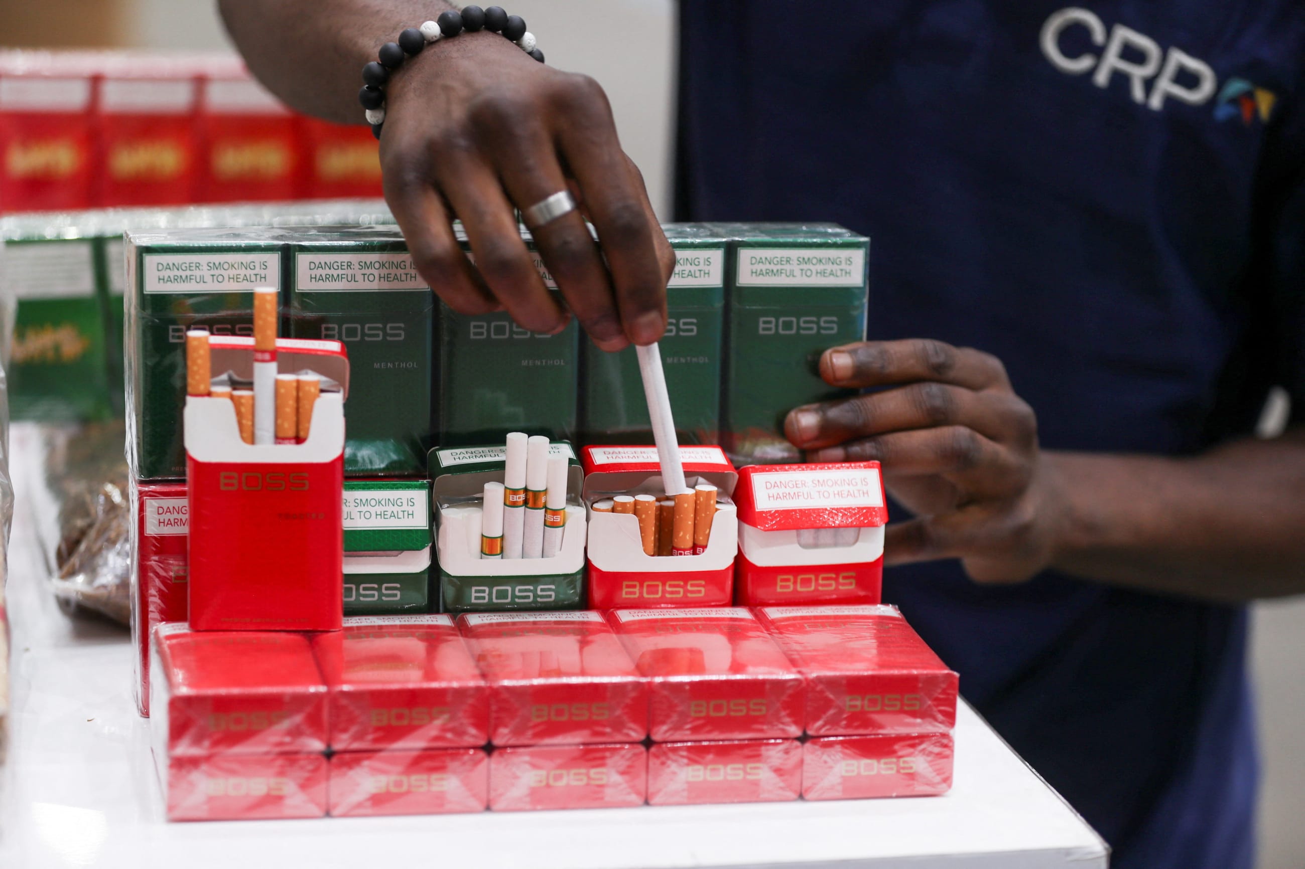 A worker packs cigarettes during the commissioning of a tobacco processing plant at Cut Rag Processors, in Harare, Zimbabwe, on November 19, 2025.