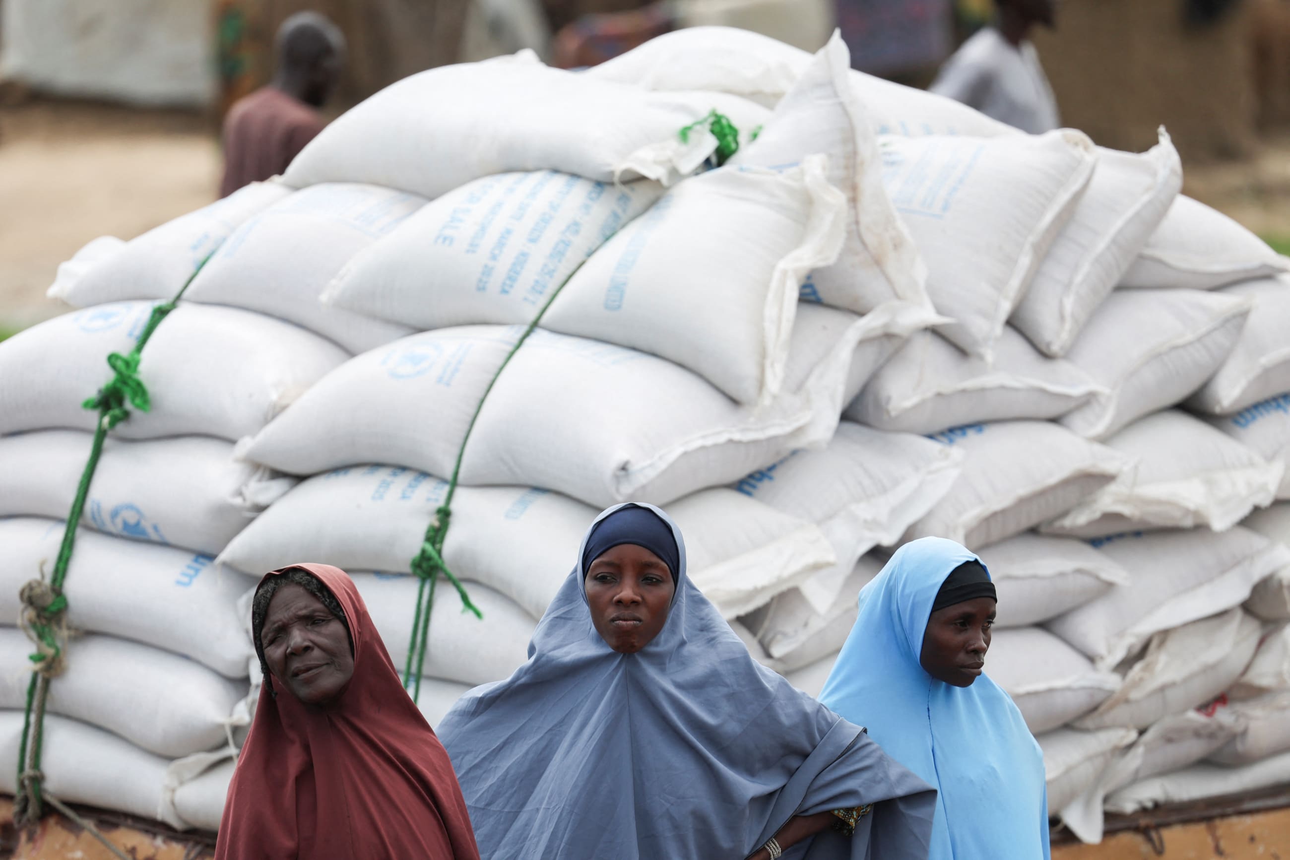 People from different Internally Displaced Persons camps wait to receive support following the exit of USAID at a World Food Program distribution center, in Dikwa, Borno State, Nigeria, on August 27, 2025.