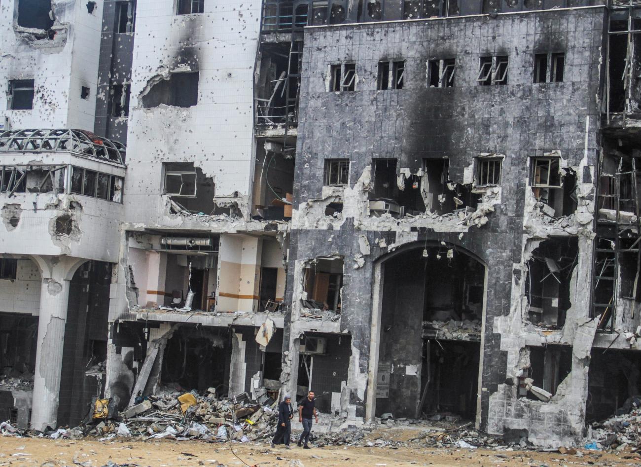 Palestinians walk at Shifa hospital following the repair of its emergency department, which was damaged in an Israeli offensive amid the Israel-Hamas conflict in the Gaza Strip, on September 1, 2024.