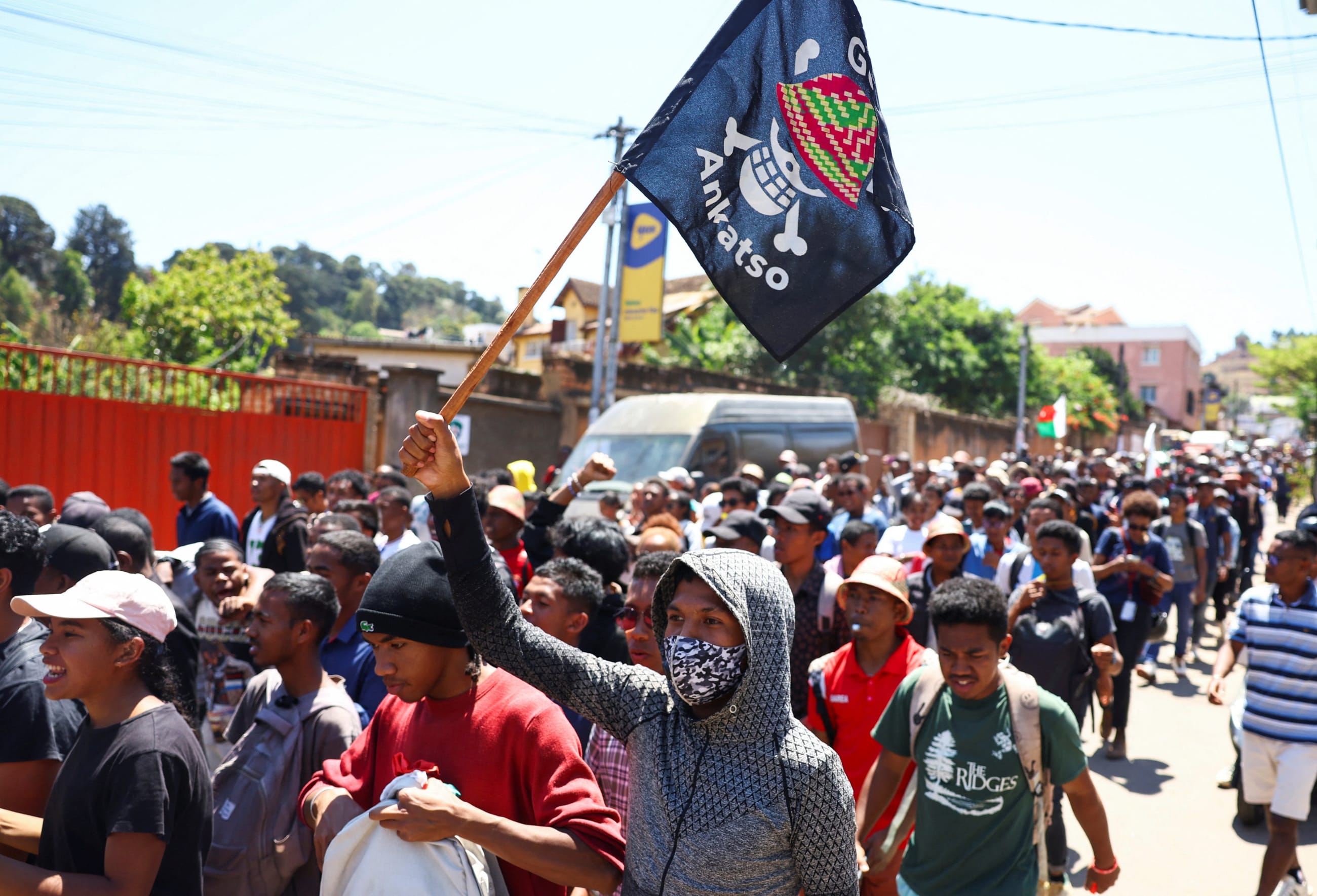 A protester carries a banner featuring a Malagasy version of the logo of the Japanese manga One Piece, as he marches in a youth-led demonstration over frequent power outages and water shortages, in Antananarivo, Madagascar, on October 13, 2025.