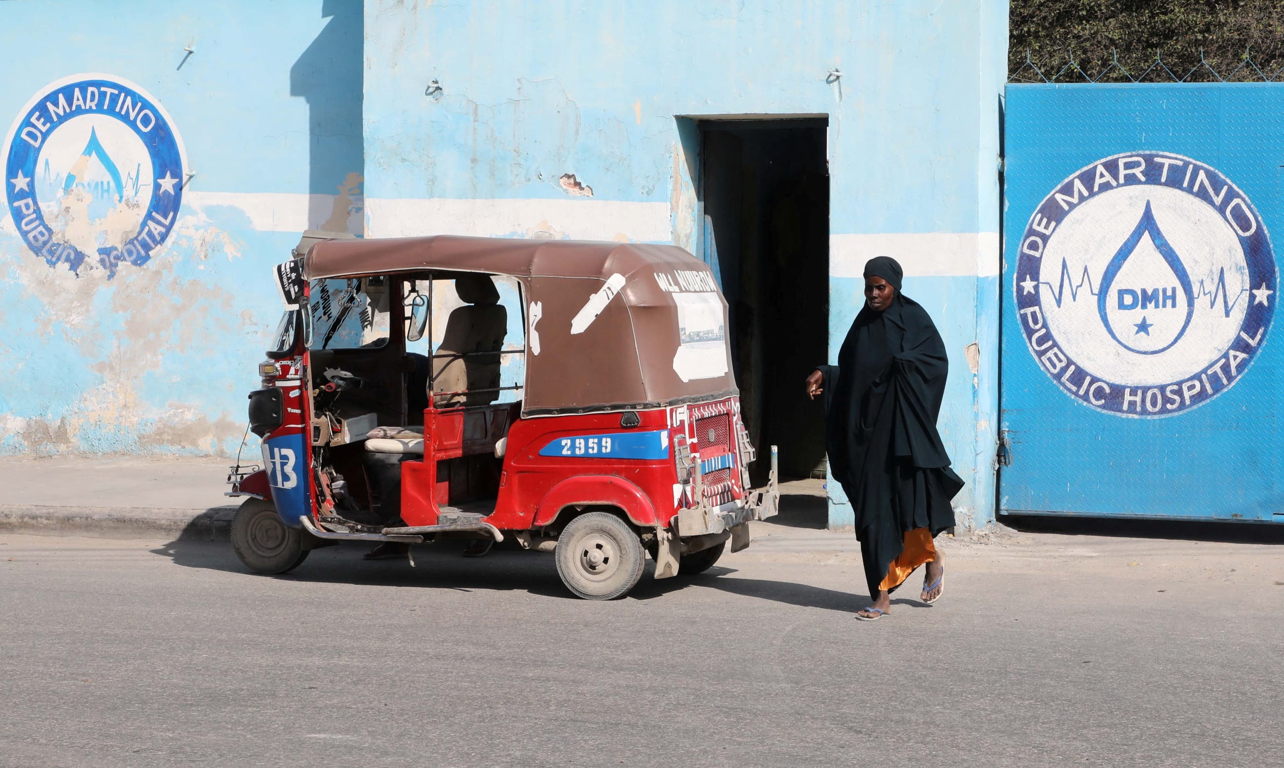 A woman walks out of De Martino Public Hospital where diphtheria patients are receiving treatment, following a diphtheria outbreak, in Mogadishu, Somalia, on August 13, 2025.