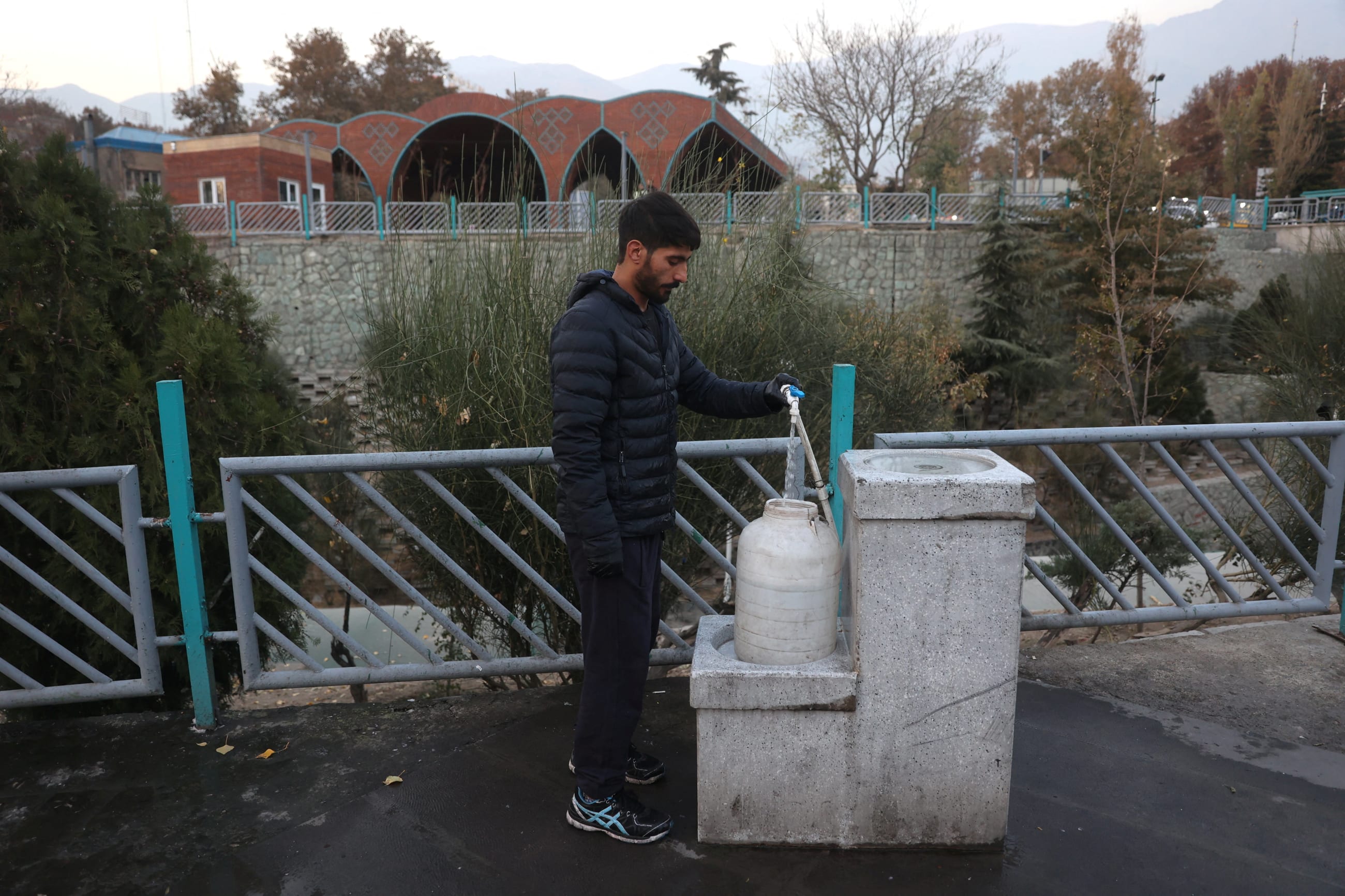 A man fills a water tank following a drought crisis in Tehran, Iran, on November 14, 2025.