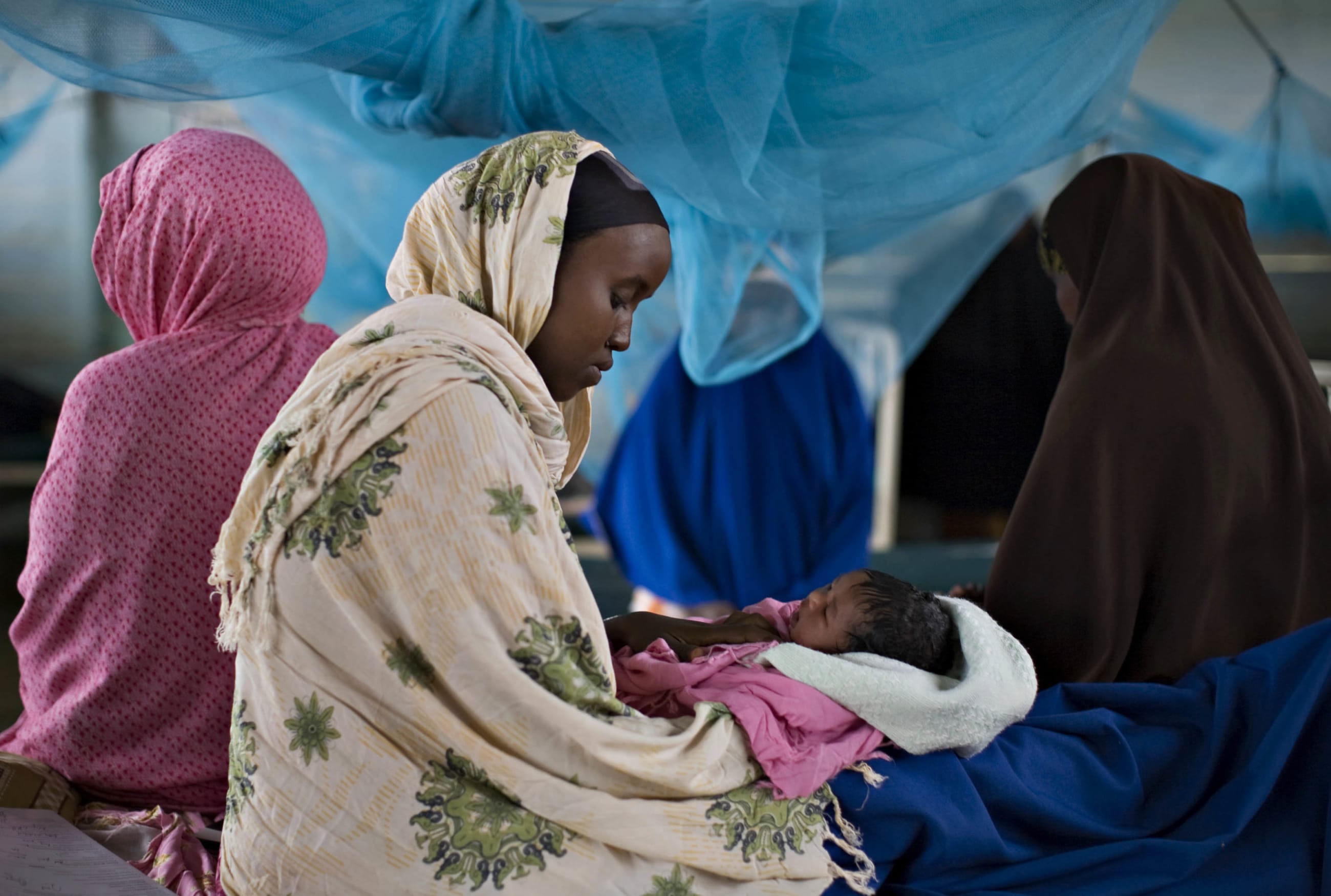 A Somali refugee holds her newborn infant in the maternity ward of a health clinic in Dagahaley camp, in Dadaab, Kenya, on June 8, 2009.
