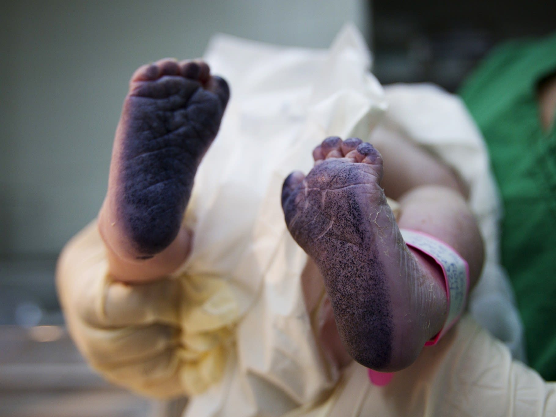 A newborn baby's inked feet are seen after his footprints were taken for the birth certificate, at the Santa Ana public maternity hospital, in Caracas, Venezuela, on October 19, 2011.