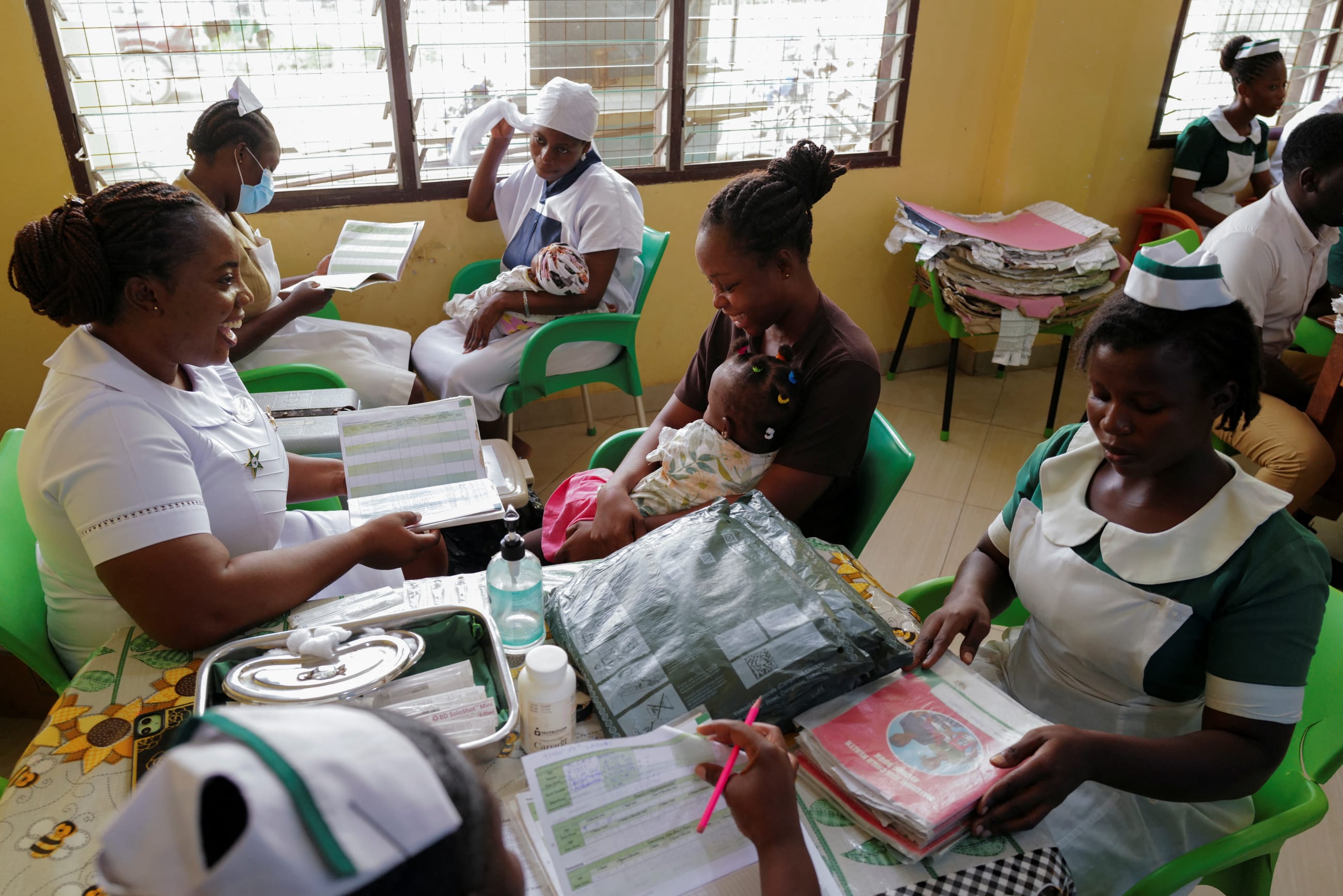 Health workers prepare to vaccinate infants at the Mother and Child Hospital in Kasoa, Ghana, on November 19, 2025.