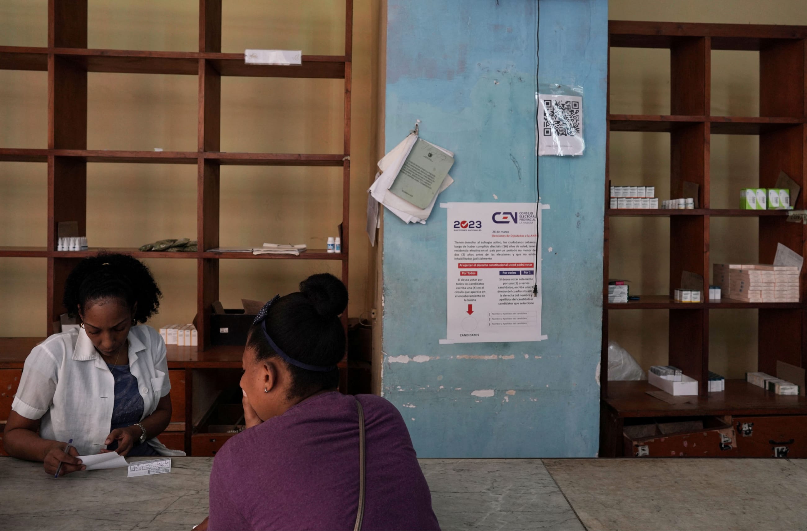 A woman buys medicine in a pharmacy, in downtown Havana, Cuba, on March 17, 2023.