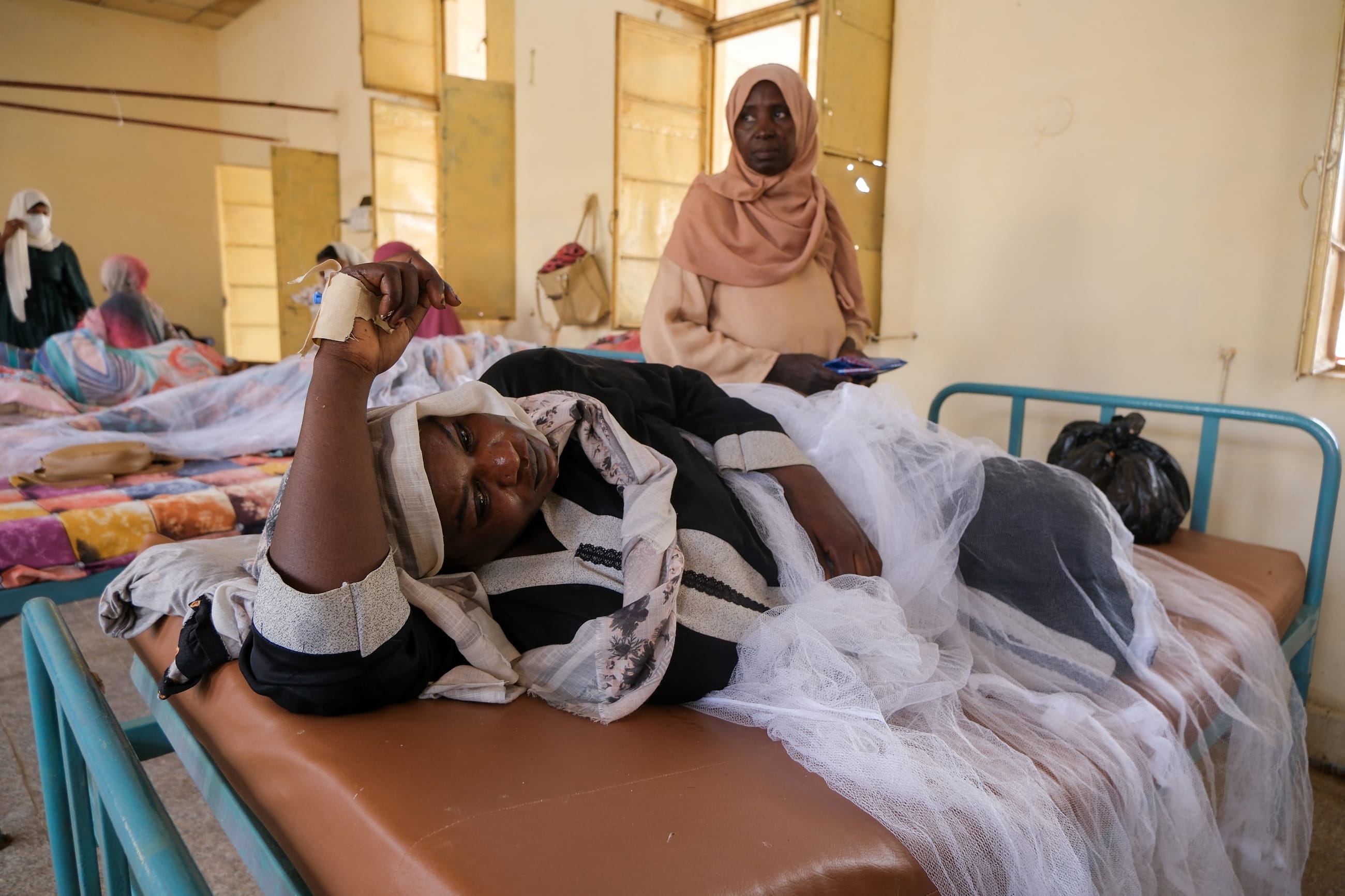 Sudanese women lie in beds as they receive treatment for dengue fever at Omdurman Hospital, in Khartoum, Sudan, on September 23, 2025.