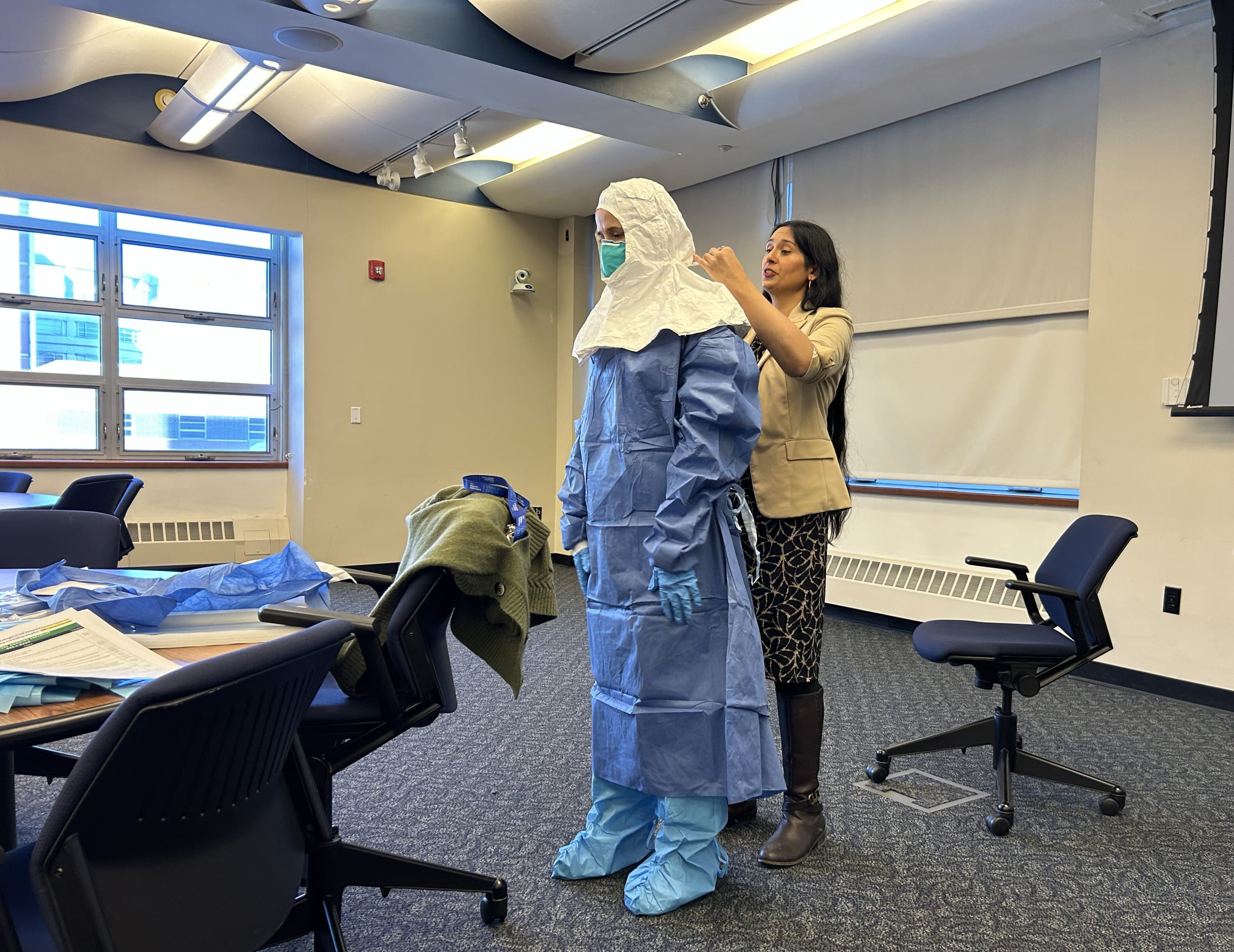 A volunteer is guided through the full donning sequence for special pathogen personal protective equipment during a training seminar led by Syra Madad, chief biopreparedness officer for NYC Health + Hospitals, on February 2, 2026.