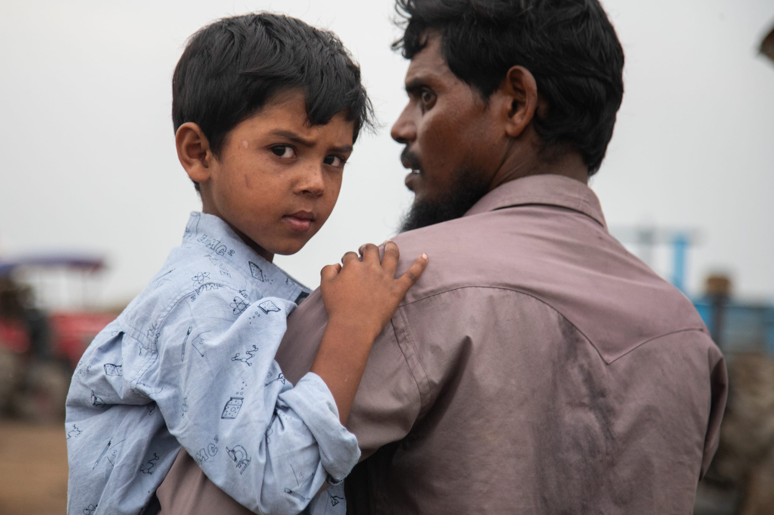 rju Mia carries his ten-year-old son , who is infected with measles , to a local pediatrician, in Kishoreganj, Bangladesh, on May 21, 2026.