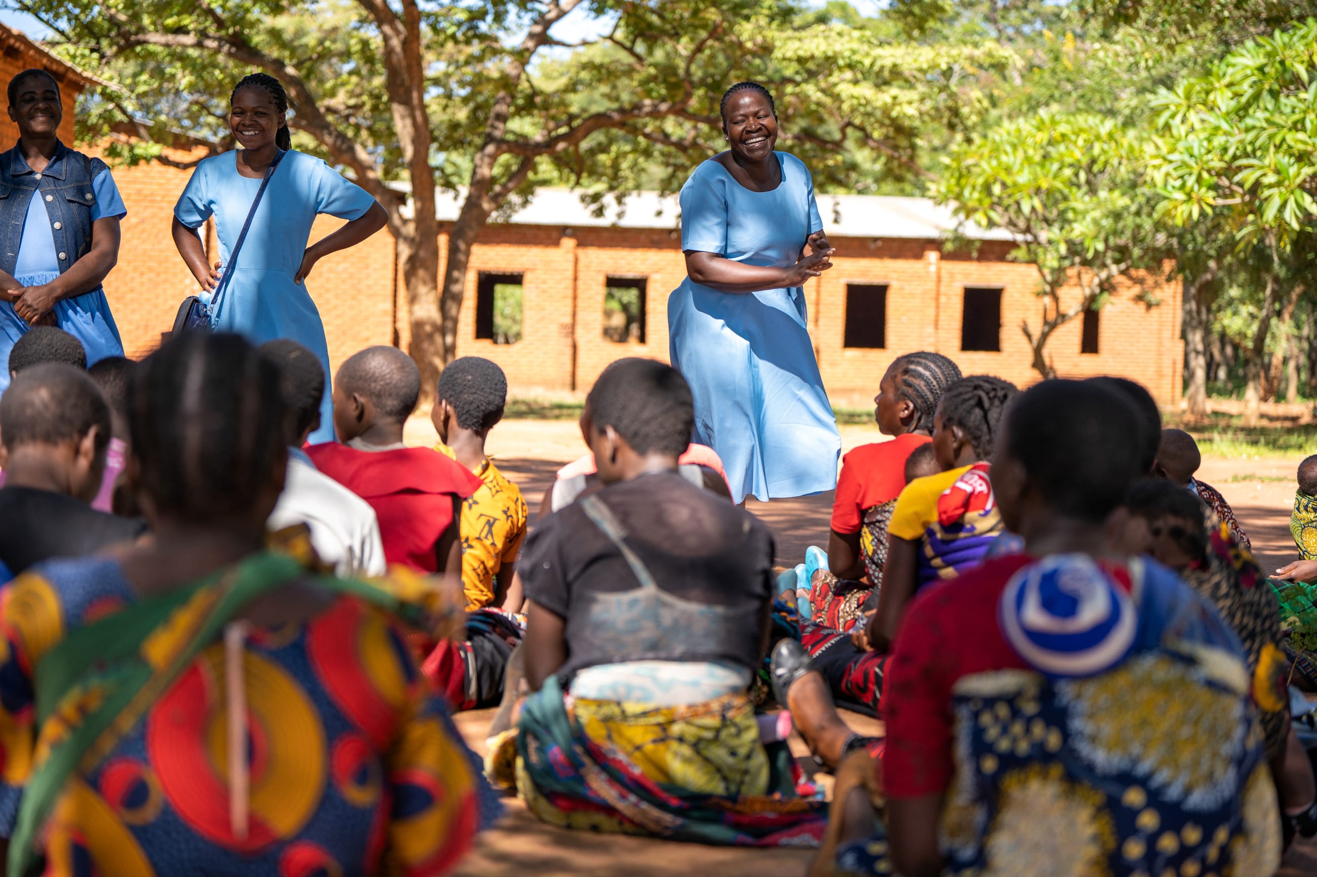 A team explains the importance of the malaria vaccine to women of the community, at Chileka Health Center, in Lilongwe, Malawi.