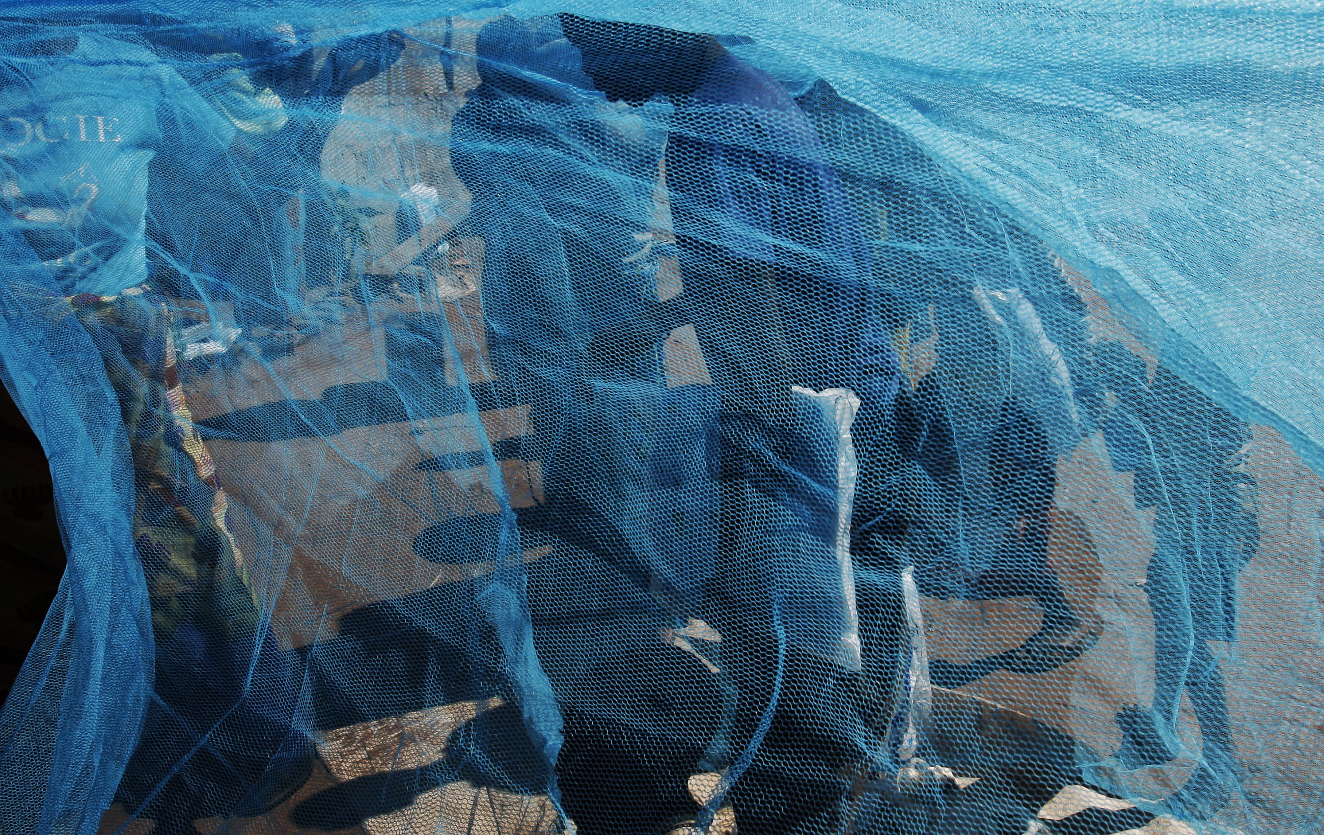 Zambian villagers display a mosquito net, in Matongo village, Zambia, on April 23, 2008.