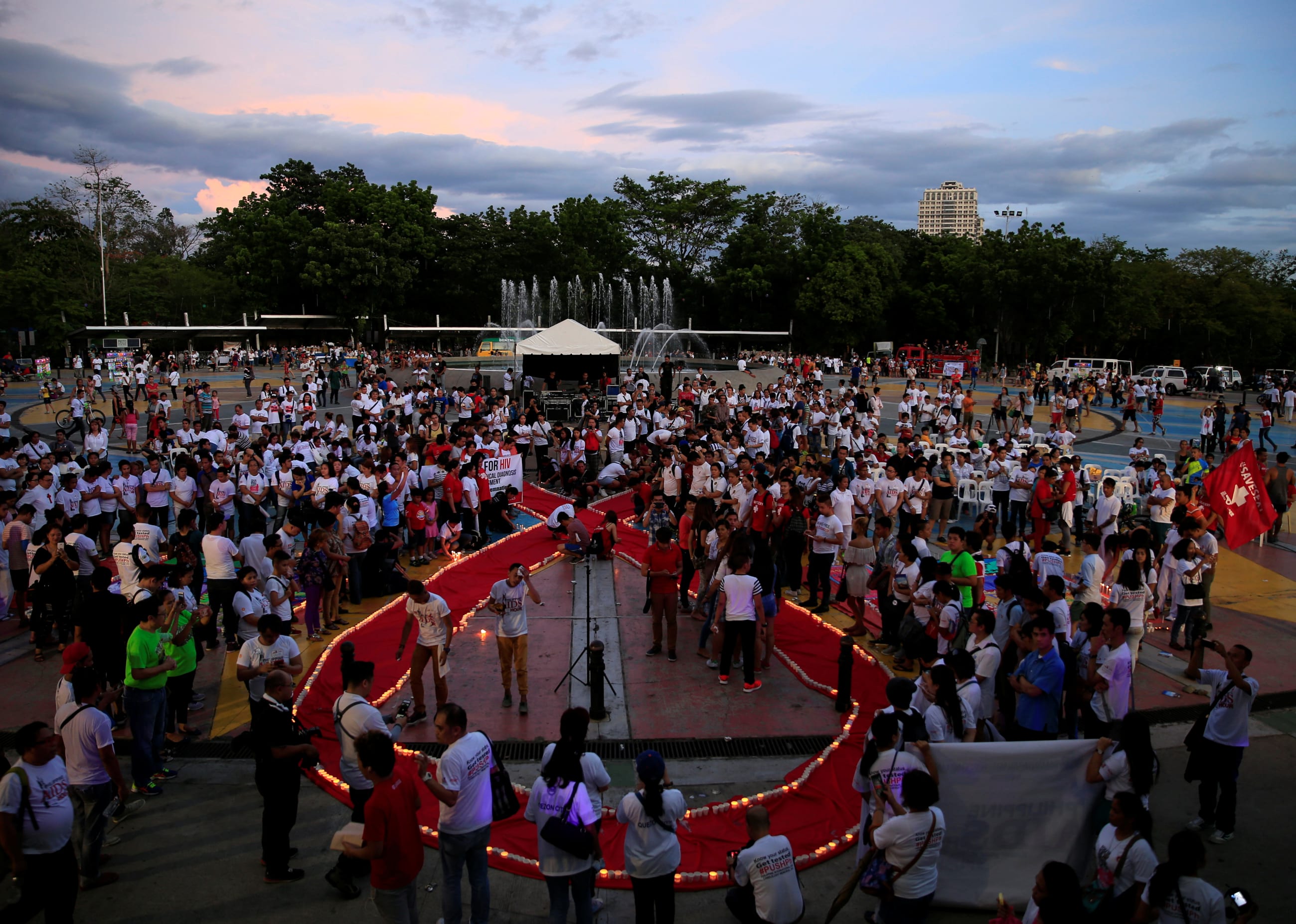Campaign supporters place candles around a large red ribbon as part of their commemoration of International AIDS Candlelight Memorial Day, in Quezon City, Philippines, on May 14, 2016.