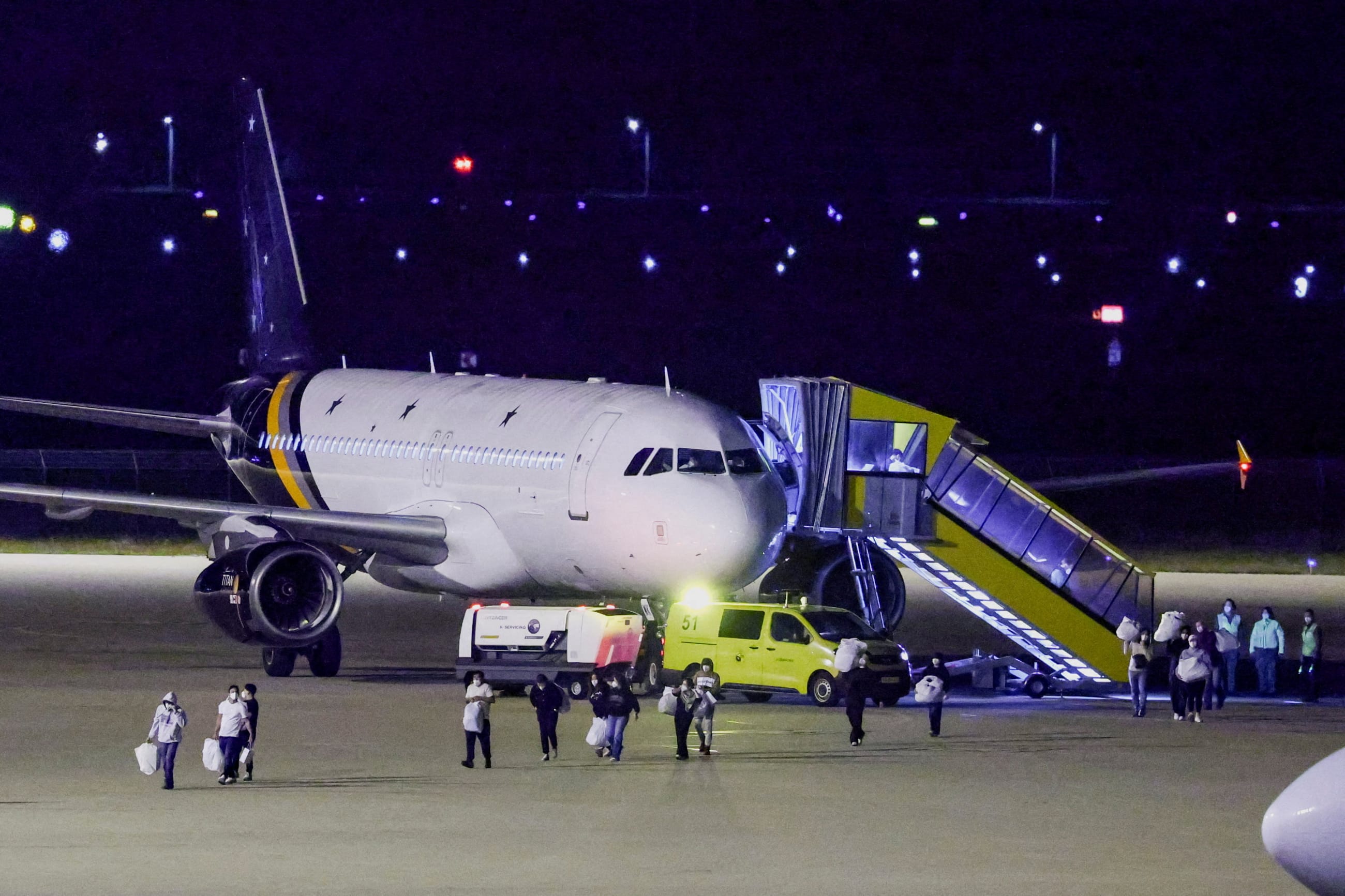 Passengers evacuated from the cruise ship MV Hondius, which was affected by a hantavirus outbreak, disembark after landing at the Eindhoven Air Base, in Netherlands, on May 12, 2026.