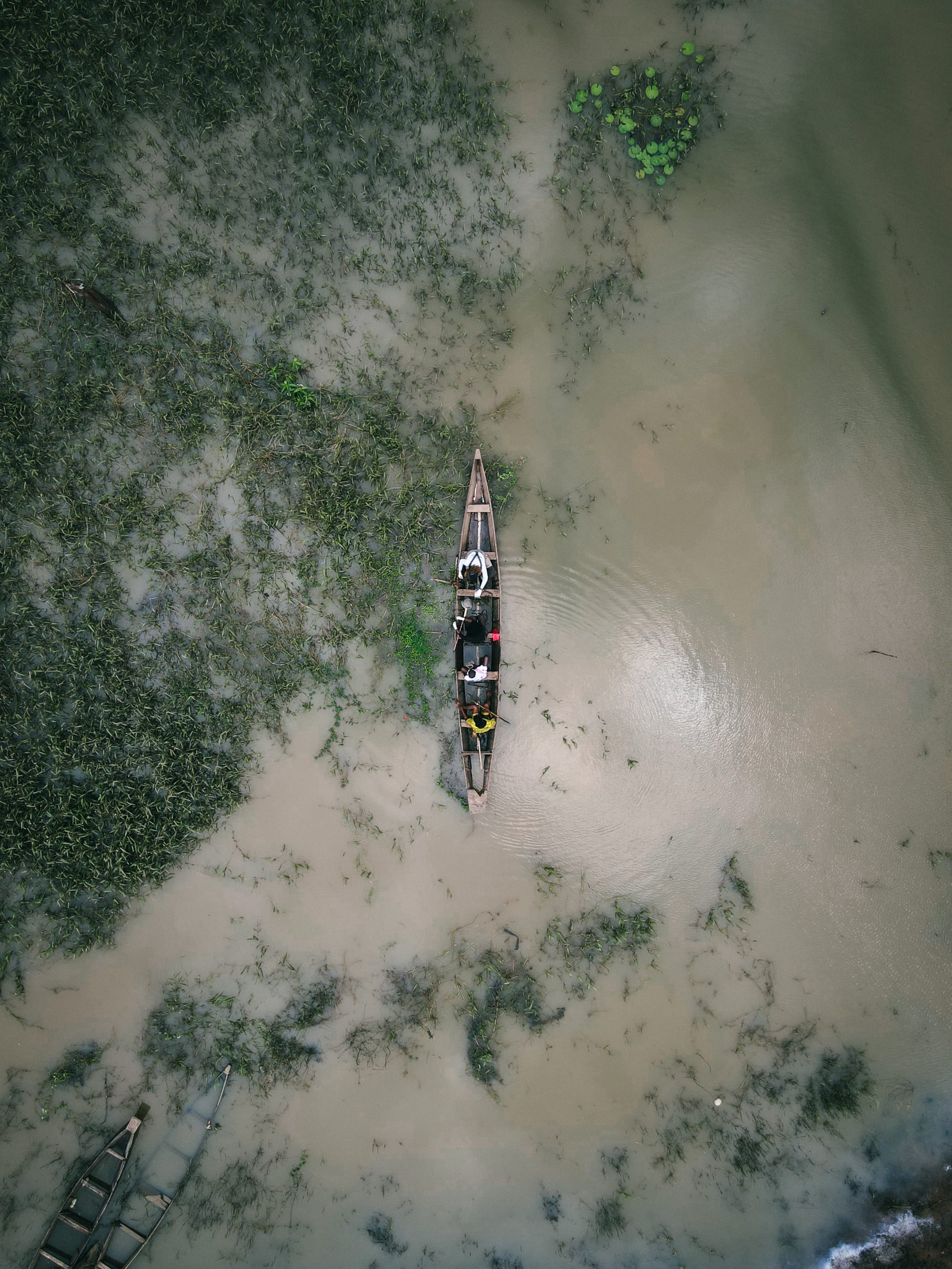 Researchers are seen collecting samples by fishing boat, photographed with drone, on July 2025.