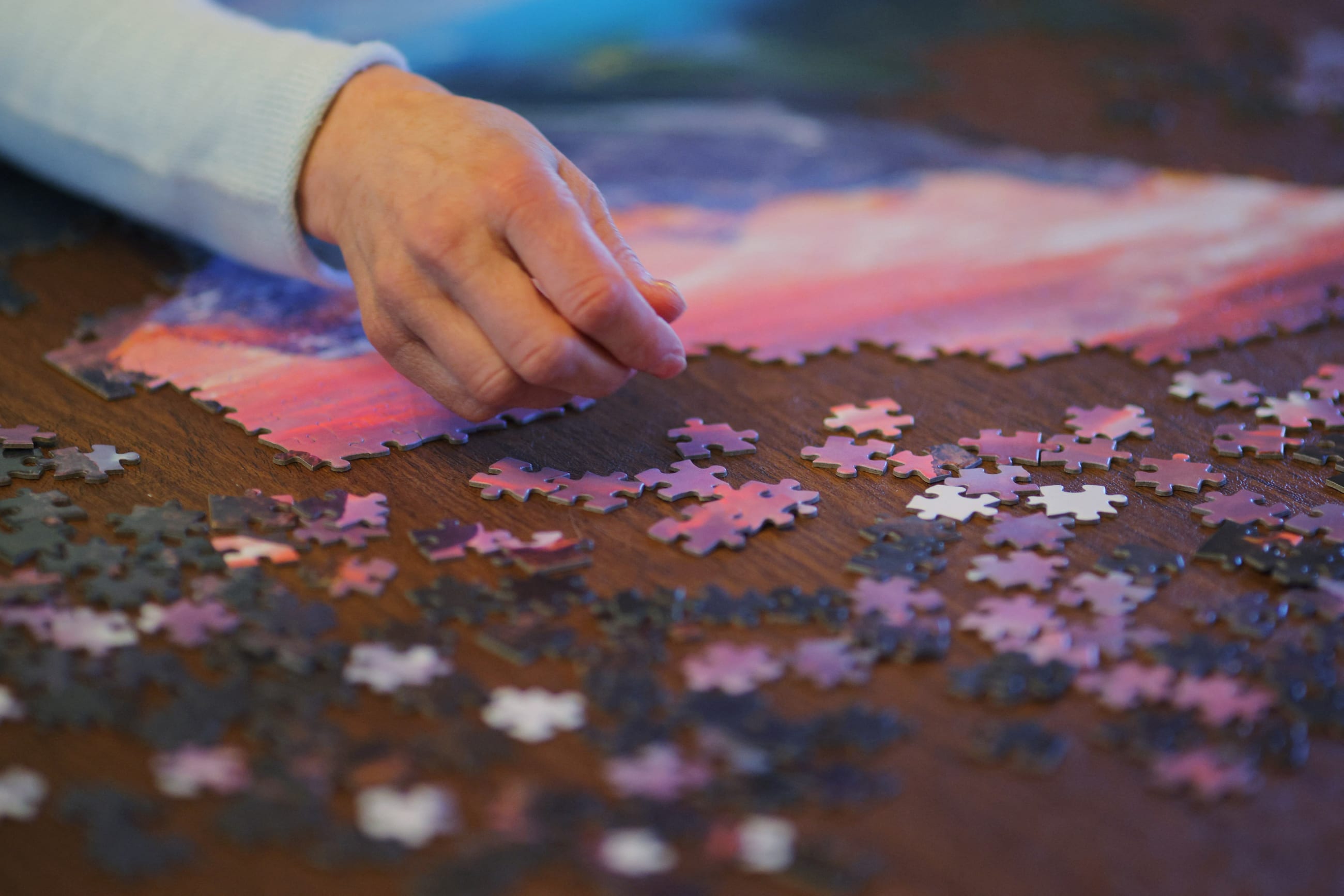 Wendy Nelson, who has genetic markers for Alzheimer's Disease, does a puzzle in her home, in Foxborough, Massachusetts, on March 21, 2023.