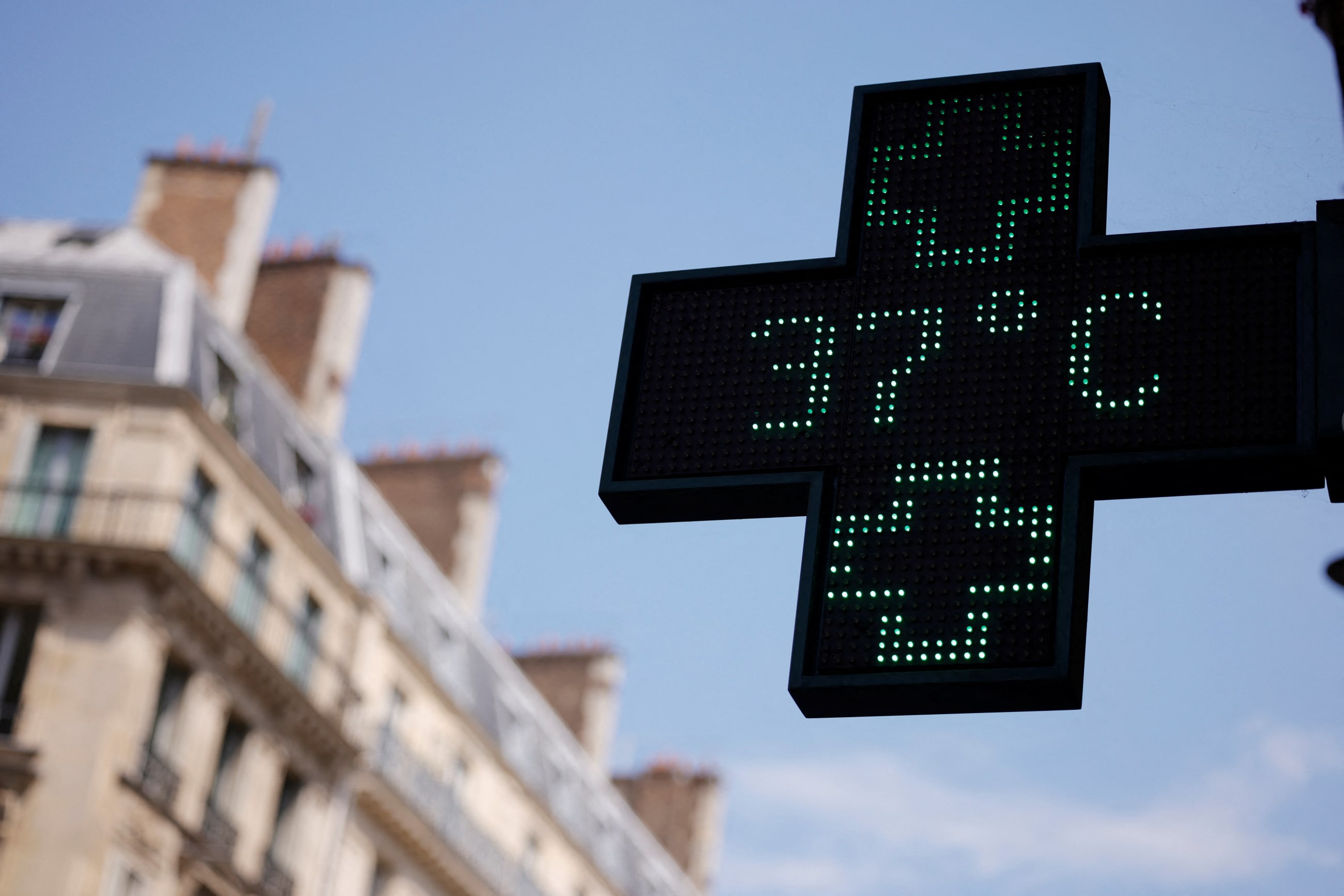 A pharmacy sign displays a temperature of 37 degrees Celsius during a heatwave, in Paris, France, on June 19, 2026.