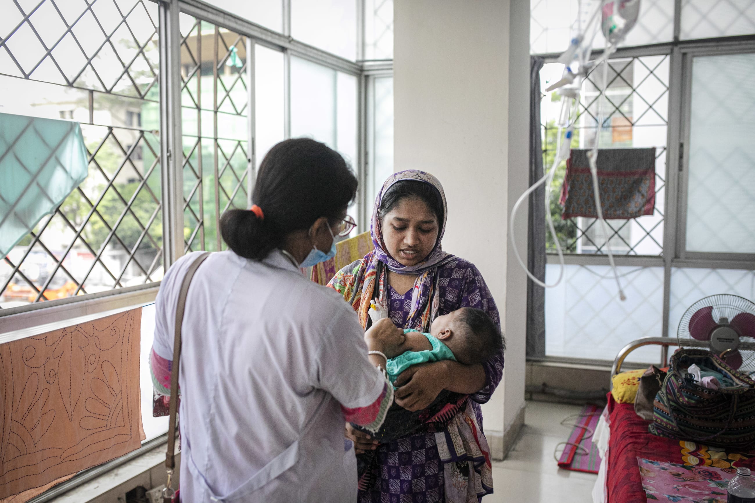 A duty doctor treats patients in the measles ward at DNCC Hospital, in Dhaka, Bangladesh, on May 24, 2026.