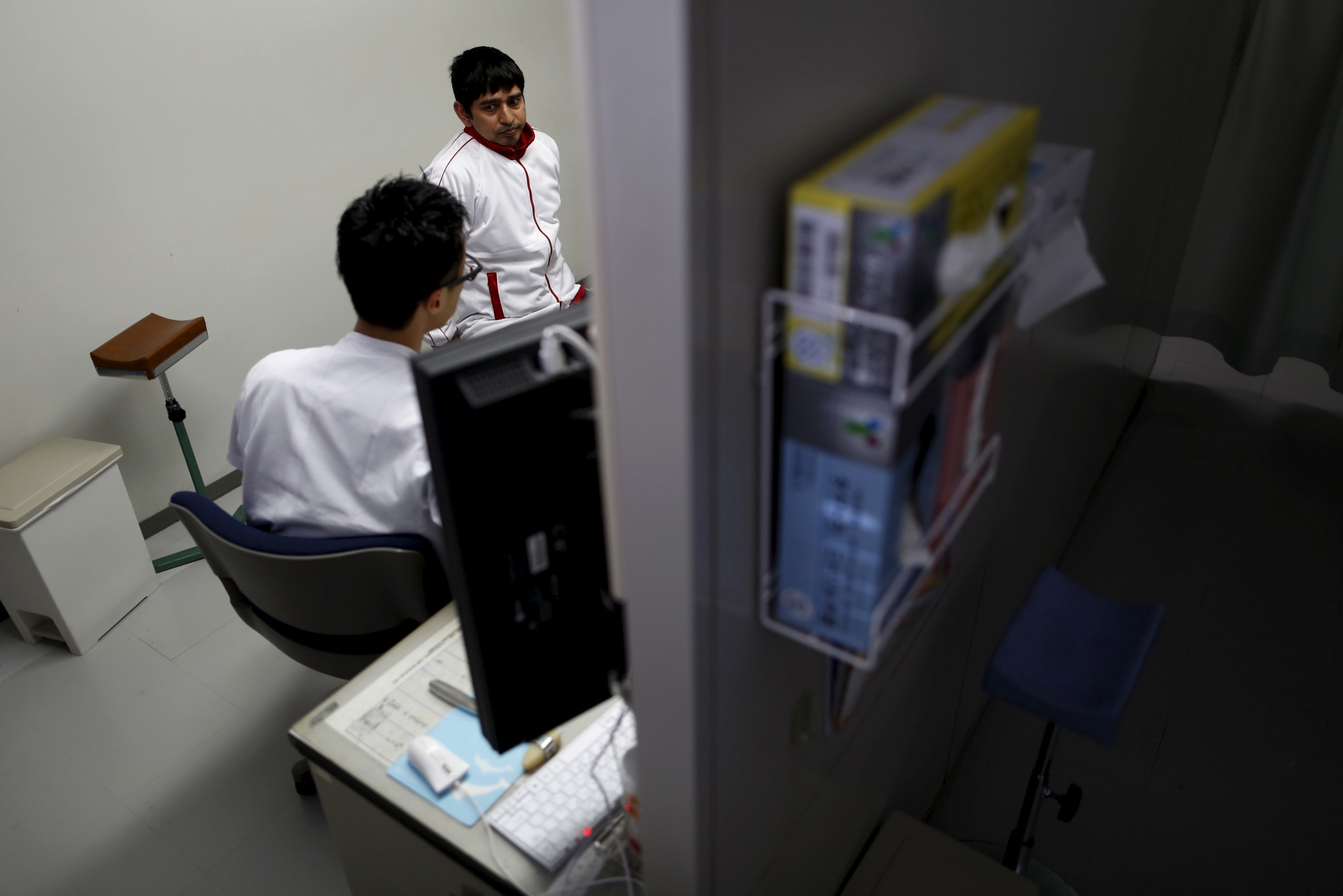 Lakhan Rijal, a 33-year-old Nepali asylum seeker, meets his doctor Takumi Takeuchi at a hospital, in Tatebayashi, Gunma prefecture, Japan, on April 24, 2015.