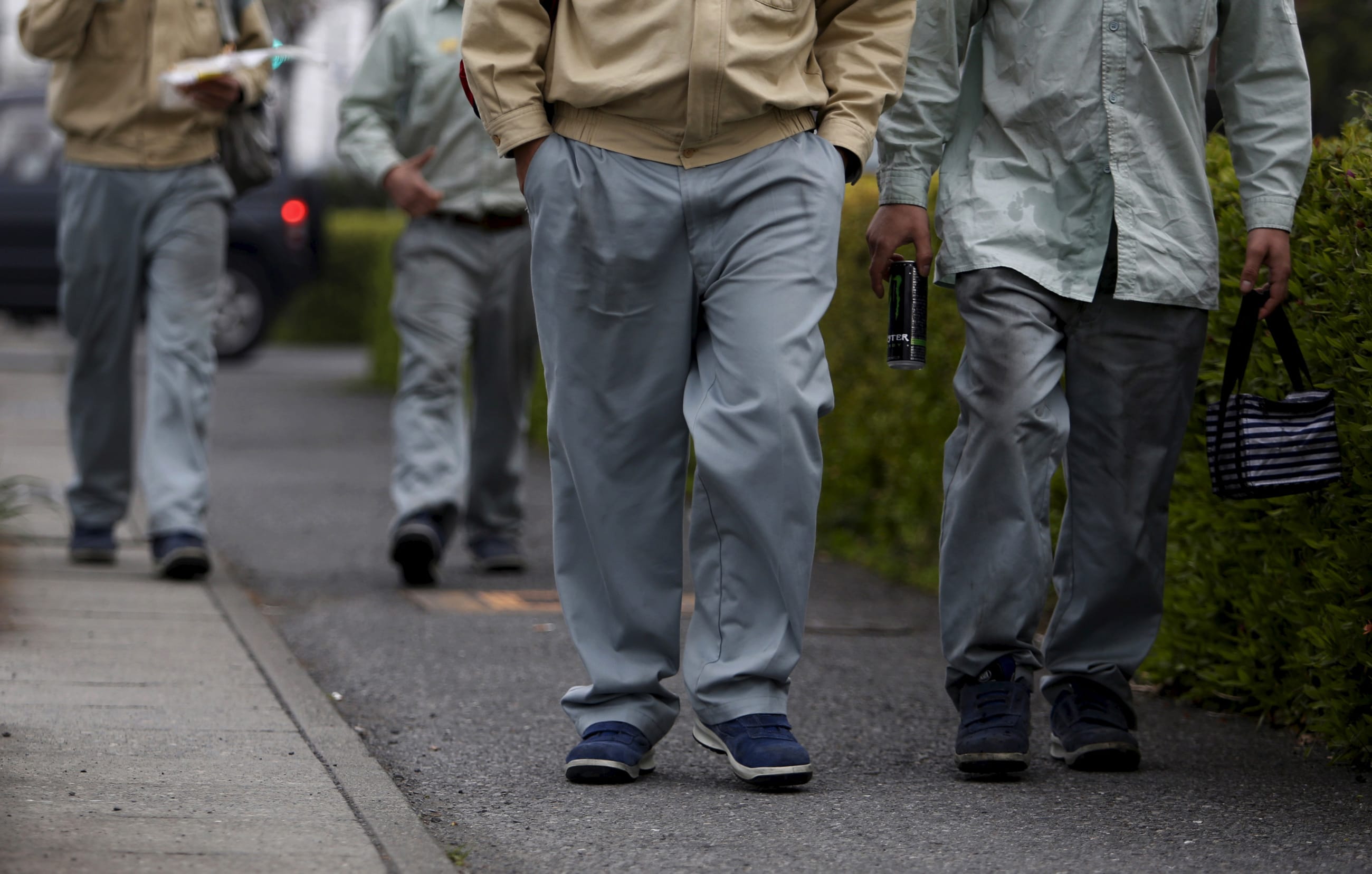 Foreign workers of NHK Spring Co, walk on a street in front of a Nippatsu factory, in Ota, Gunma prefecture, Japan, on April 24, 2015.