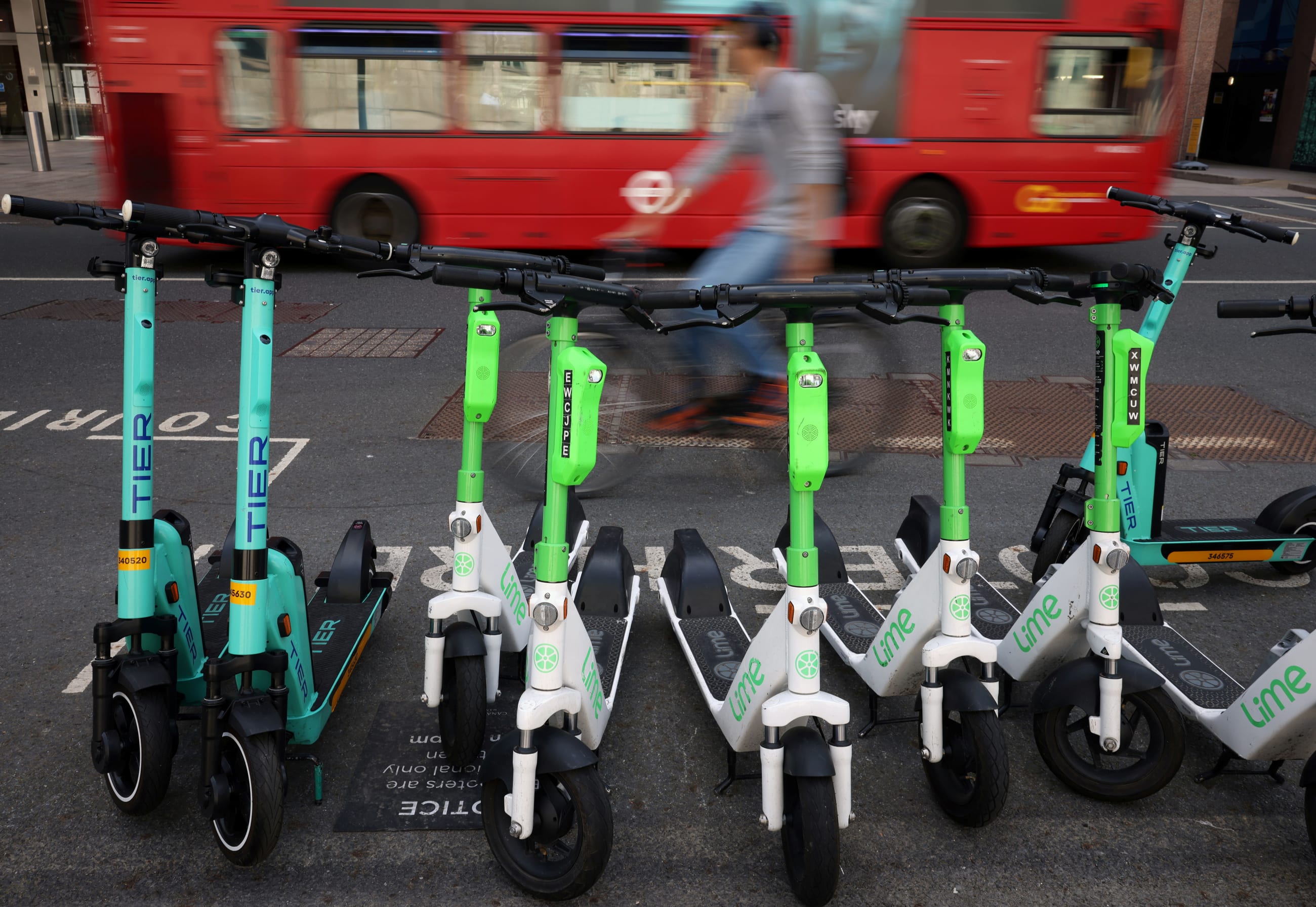 A row of e-scooters from Tier and Lime are seen in Canary Wharf, in London, Britain, on May 18, 2022.