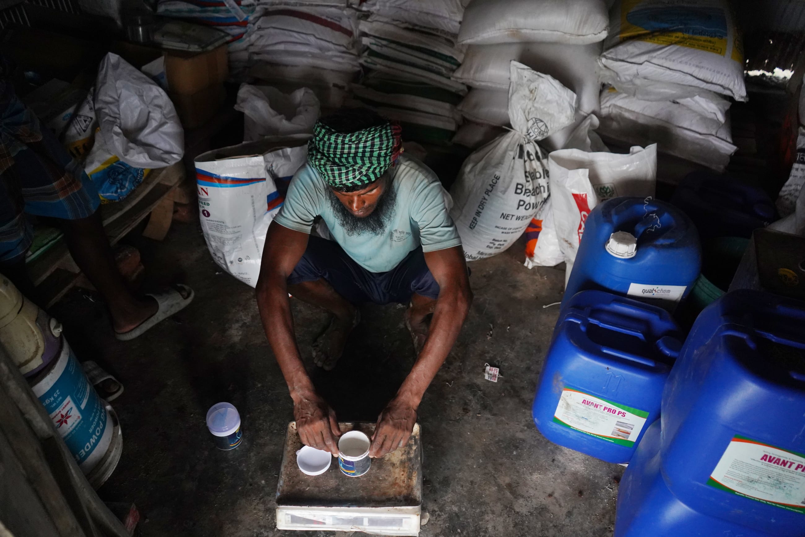 A laborer mixes feed for a shrimp pond in Koyra, Khulna, preparing the daily ration for the growing stock. Photo taken on April 18, 2026, from subdistrict Koyra, in the district of Khulna.