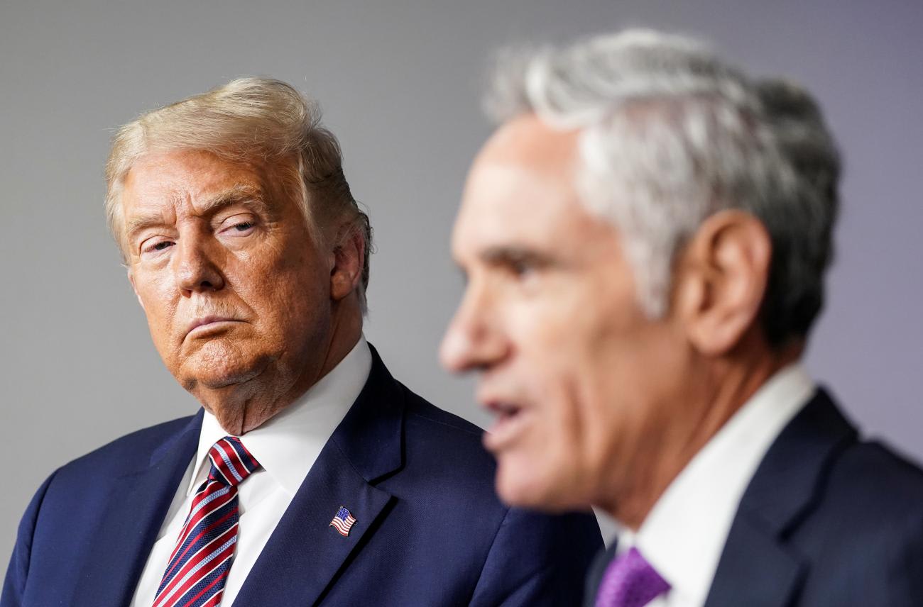 U.S. President Donald J. Trump listens as Dr. Scott Atlas speaks during a briefing on the COVID-19 pandemic response at the White House in Washington, DC on August 12, 2020.