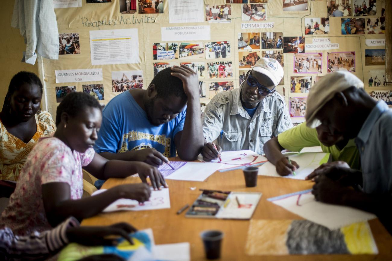 Six patients undergo a rehabilitation program draw during a group therapy session at the Sopi Jikko mental health center in Dakar