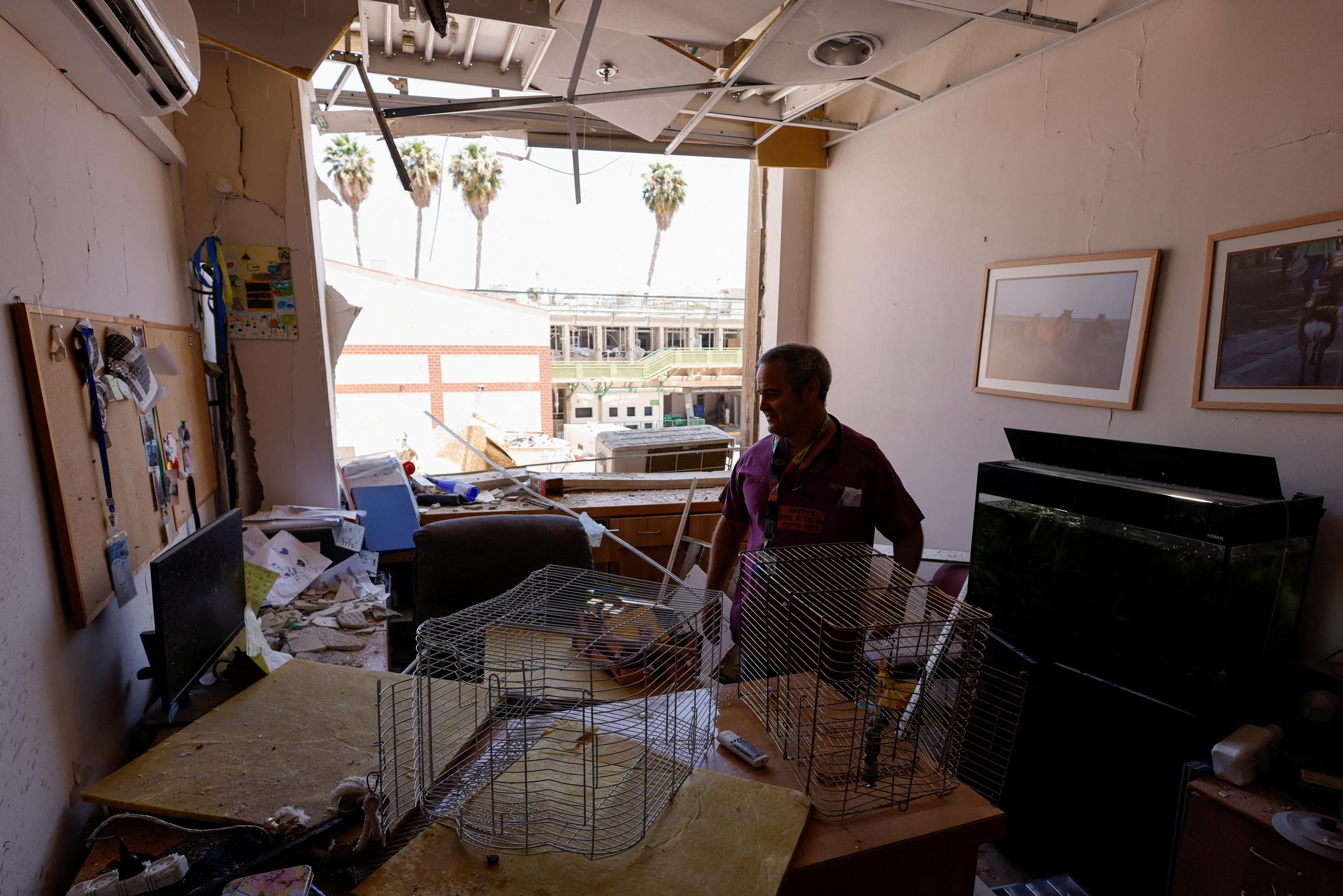 A person inspects the damage at an impact site, following a missile strike from Iran on Israel, at Soroka Medical Center, in Beersheba, Israel, on June 19, 2025.