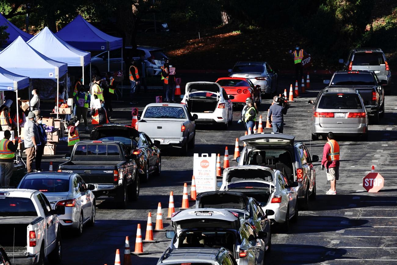 People wait in their vehicles at a drive-thru food distribution organized by the Los Angeles Regional Food Bank, as the U.S. Senate grapples with whether to increase payments to Americans reeling from the coronavirus disease (COVID-19) pandemic, in West Covina, California, U.S. December 29, 2020.