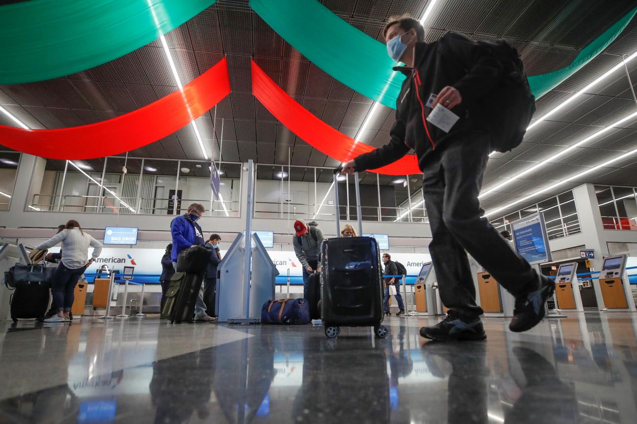 Travelers check in for their flights at O'Hare International Airport ahead of the Thanksgiving holiday during the coronavirus disease pandemic, in Chicago,Illinois on November 25, 2020.