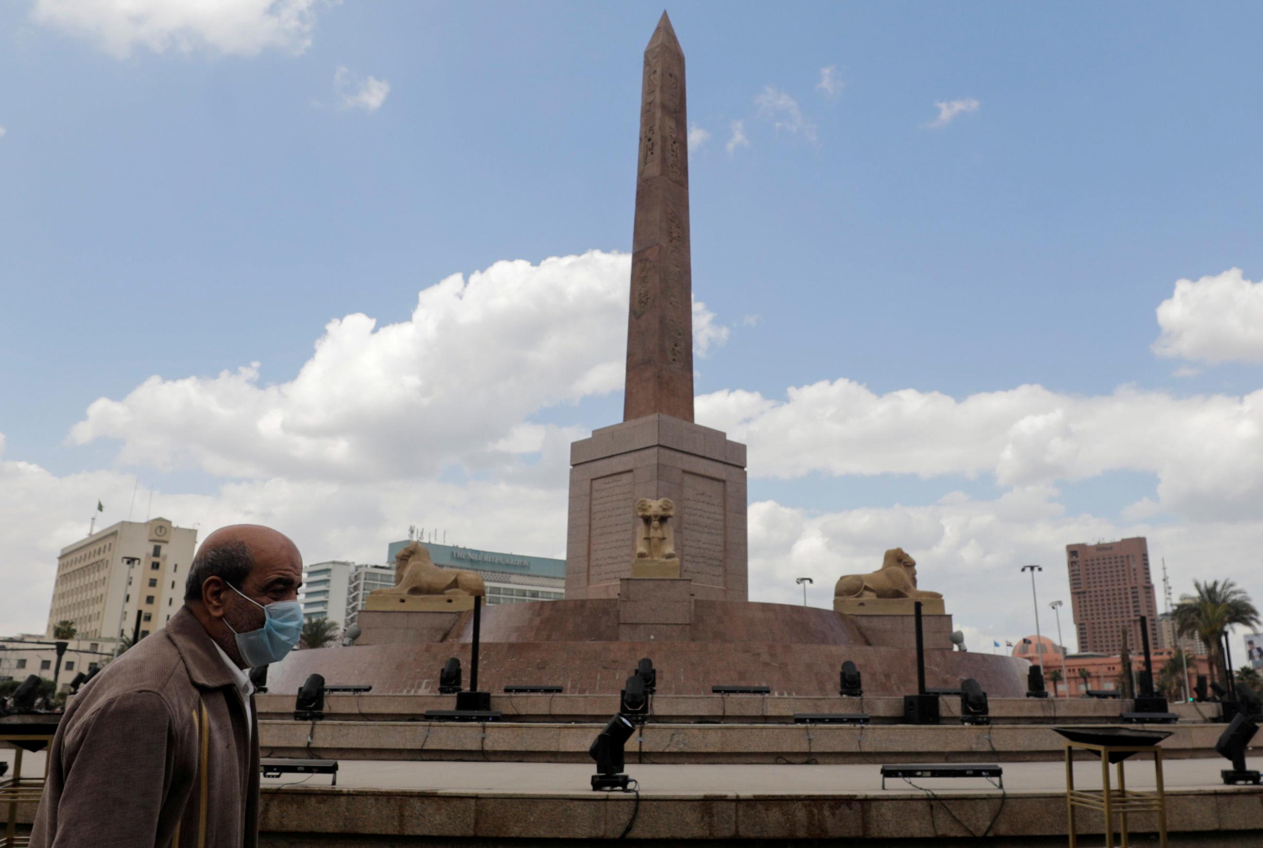 A man walks past the Ramses II obelisk in Tahrir Square in Cairo, Egypt on April 1, 2021. on