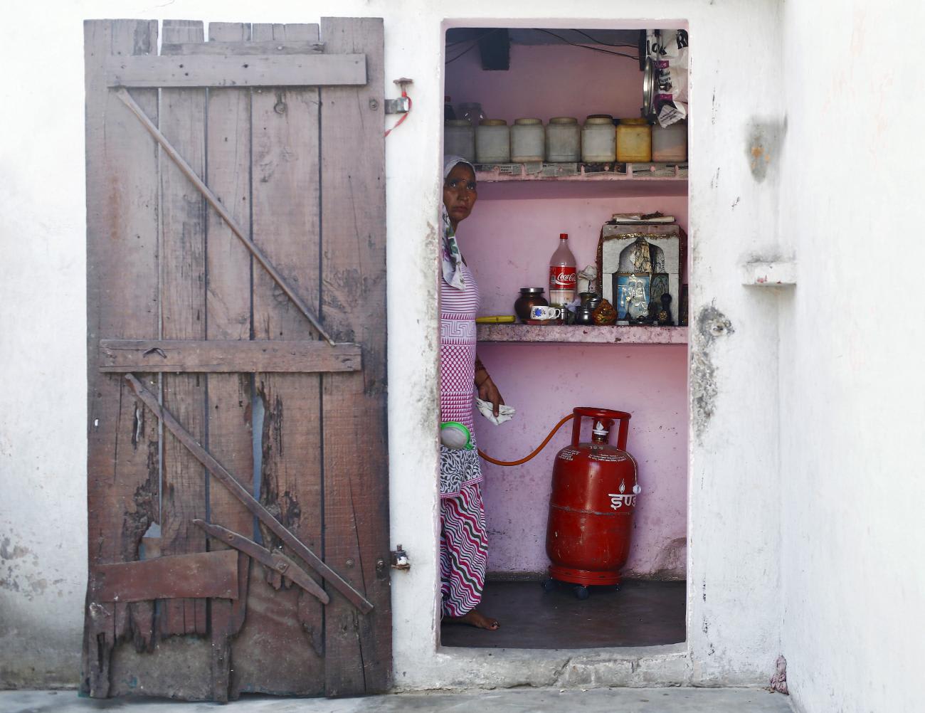 A housewife cooks in her kitchen at Dujana village in Noida, near New Delhi, India, on October 7, 2015.