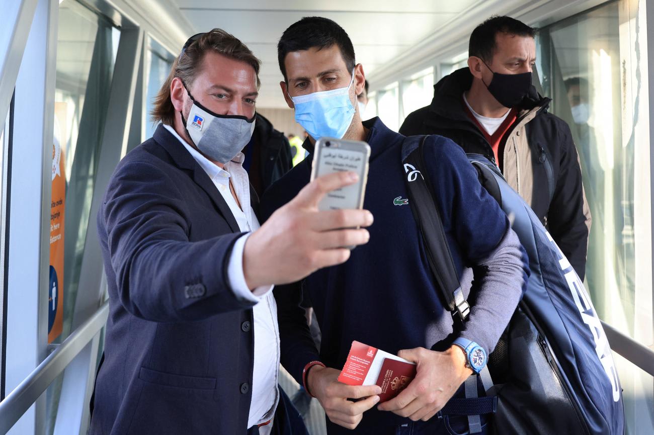 A man takes a selfie with Serbian tennis player Novak Djokovic as he arrives at Nikola Tesla Airport, after the Australian Federal Court upheld a government decision to cancel his visa to play in the Australian Open, in Belgrade, Serbia January 17, 2022.