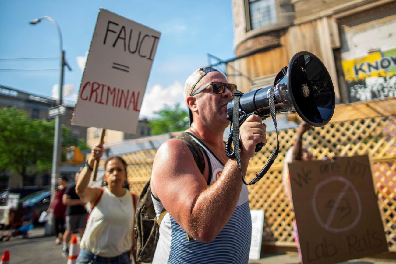 People hold a protest near the Abyssinian Baptist Church, where U.S. First Lady Jill Biden and Dr. Anthony Fauci are visiting a vaccination clinic, in Harlem, New York, U.S., June 6, 2021.