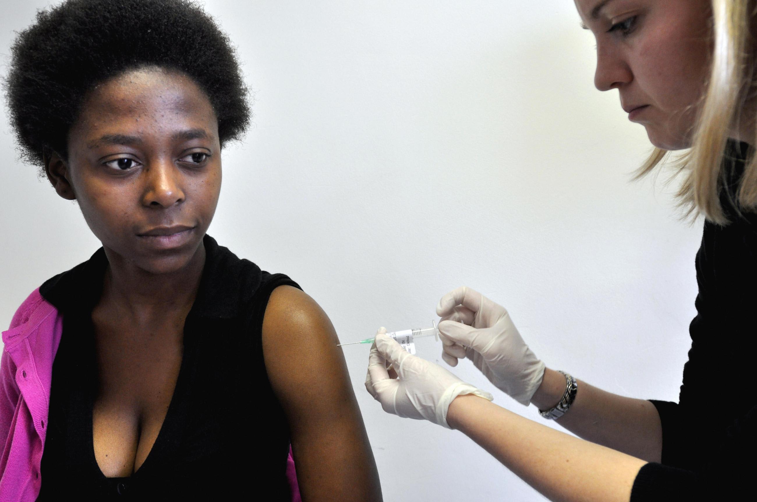 Physician Camilla Samways with volunteer Nobathembu Mbembe who is receiving the African-produced HIV vaccine at the iEmavundleni Centre, in Crossroads, Cape Town, South Africa, on July 28, 2009.
