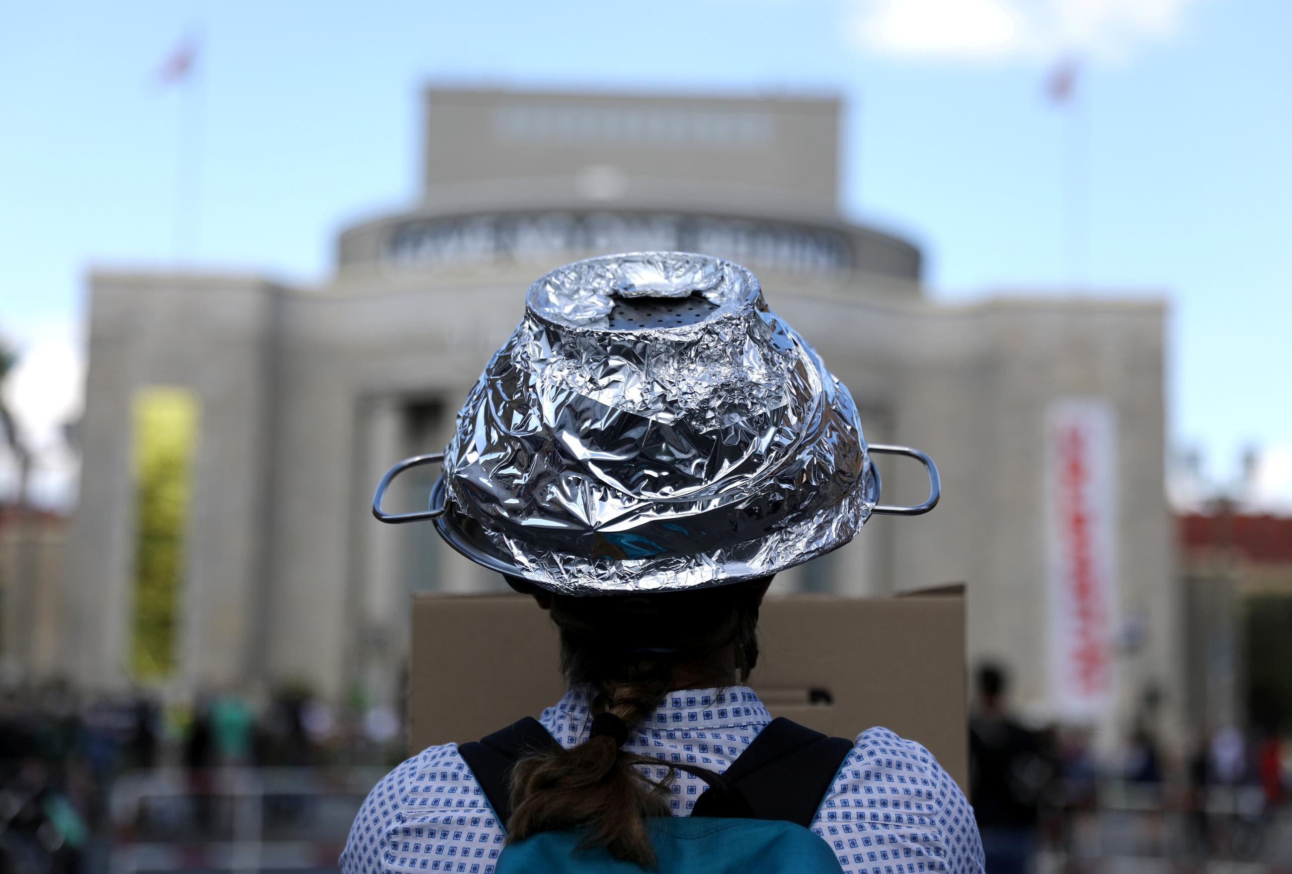 A woman attends a protest of conspiracy theorists and other demonstrators at Rosa Luxemburg Platz, amid the spread of the coronavirus disease (COVID-19), in Berlin, Germany May 9, 2020.