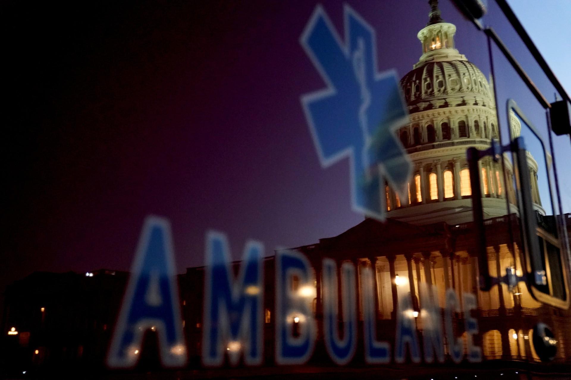 The U.S. Capitol dome is reflected on an ambulance at sunset in Washington, DC, on November 10, 2020.