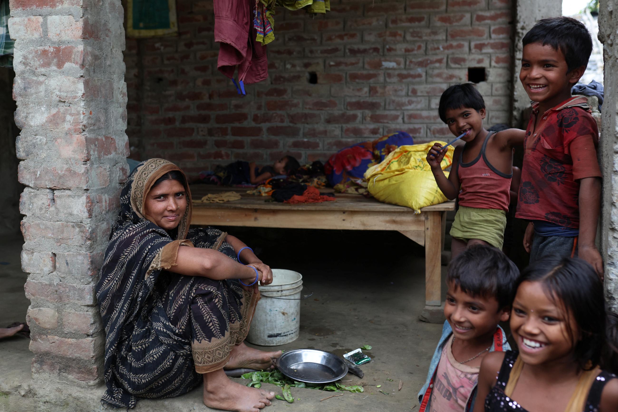 Masera Khatun, thirty-seven, who is pregnant with her sixth child, sits outside her house at Duadangi village in the Bahadurganj subdivision of Kishanganj district, Bihar, India, on March 21, 2023.