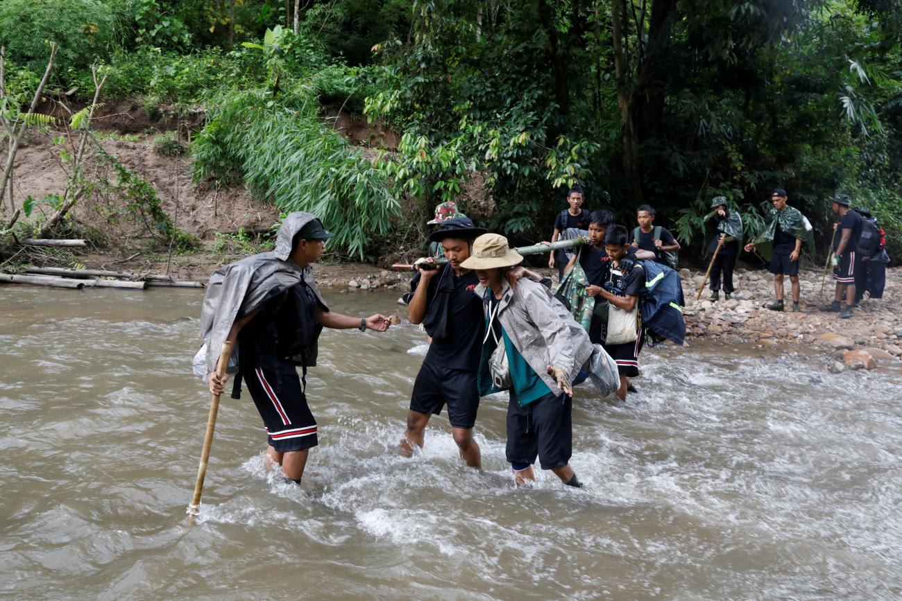 Members of the People's Defence Force carry a fellow fighter who was injured at a training camp in an area controlled by ethnic Karen rebels, Karen State, Myanmar, on September 10, 2021. REUTERS/Independent photographer