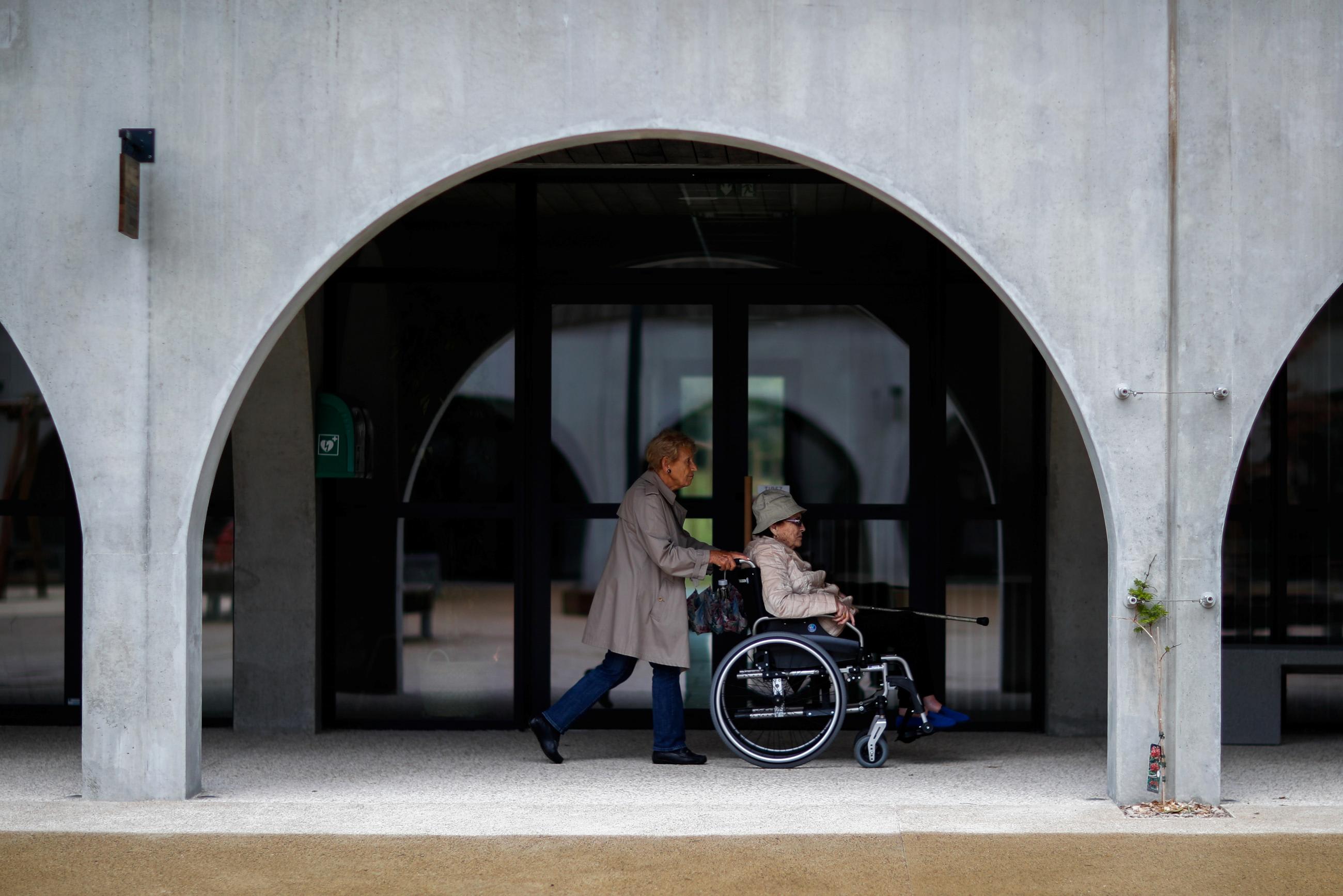 Alzheimer's patients Marie-Christiane pushes Jaqueline, ninety-two, on her wheelchair during a walk at the Village Landais Alzheimer site in Dax, France, September 24, 2020.