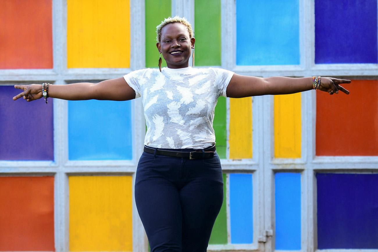 Joan Amek, twenty-seven, an LGBTQ+ rights activist and executive director of Rella Women's Empowerment Program, poses for a photograph with rainbow colors at their offices after a Reuters interview in Kulambiro suburb of Kampala, Uganda, on April 4, 2023.