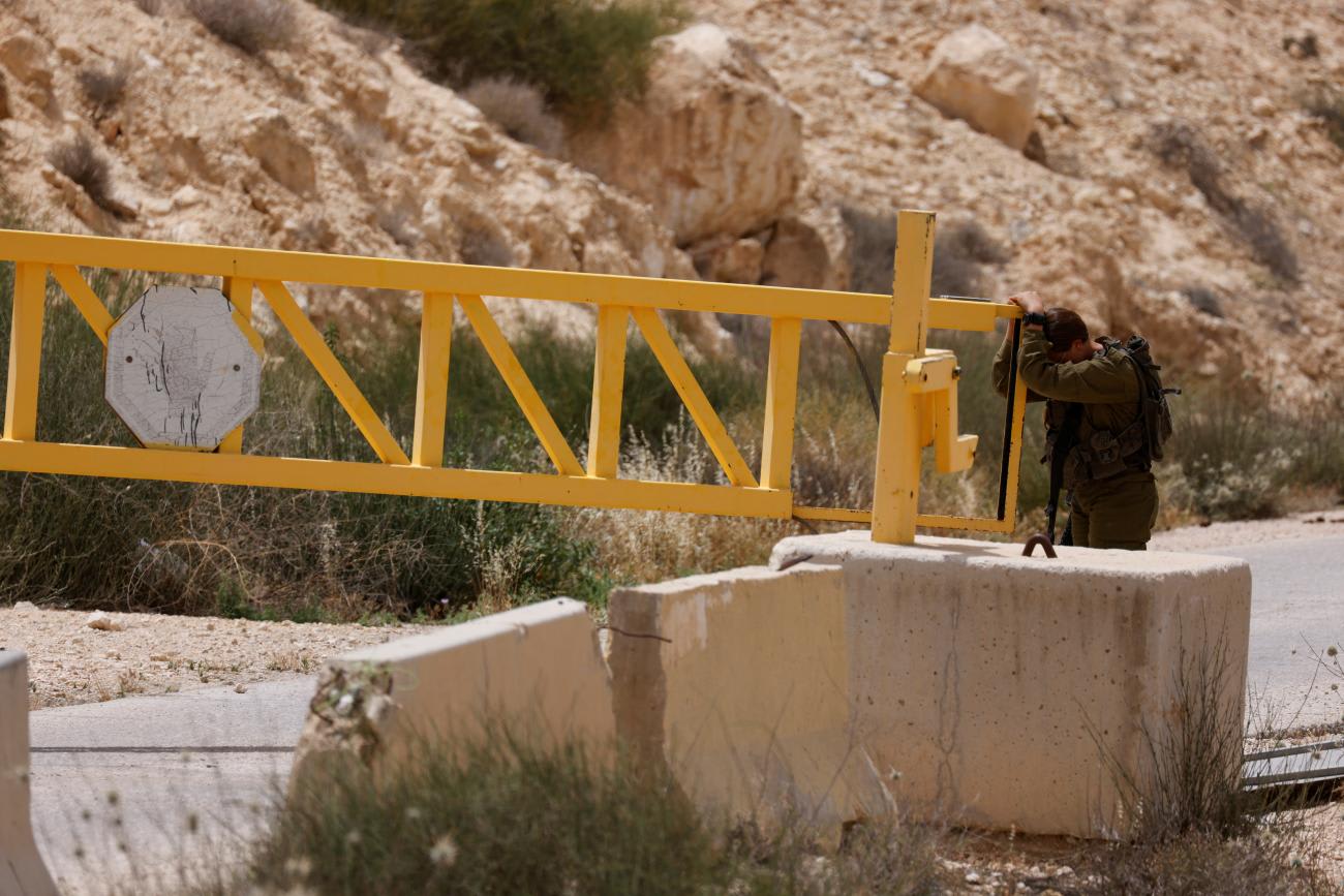 A soldier reacts at the gate near the site of a reported security incident near Israel's southern border with Egypt, on June 3, 2023.