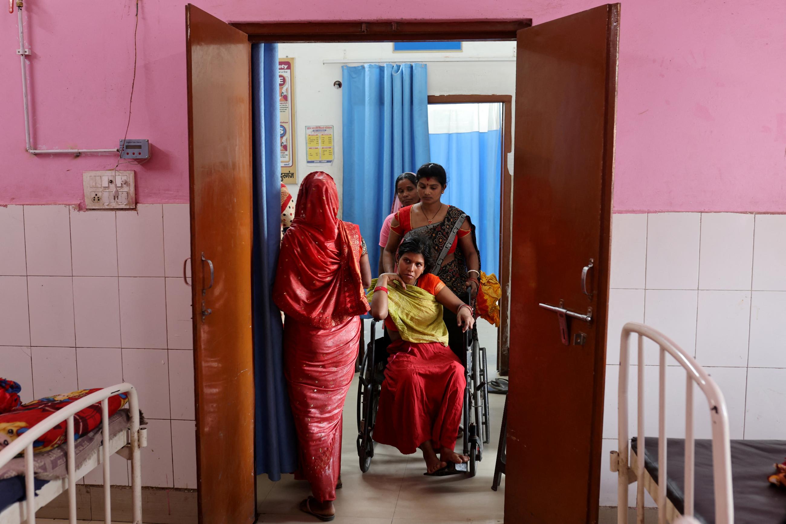 Sabina Begum, 22, sits in a wheelchair after she gave birth in the maternity ward of a community health center in Bahadurganj subdivision of Kishanganj district, Bihar, India, on March 21, 2023.