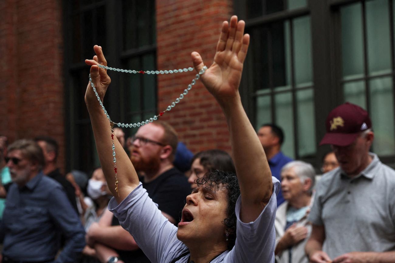 A person holds a rosary in a crowd of anti-abortion activists praying outside the Planned Parenthood Manhattan Health Center in New York City.