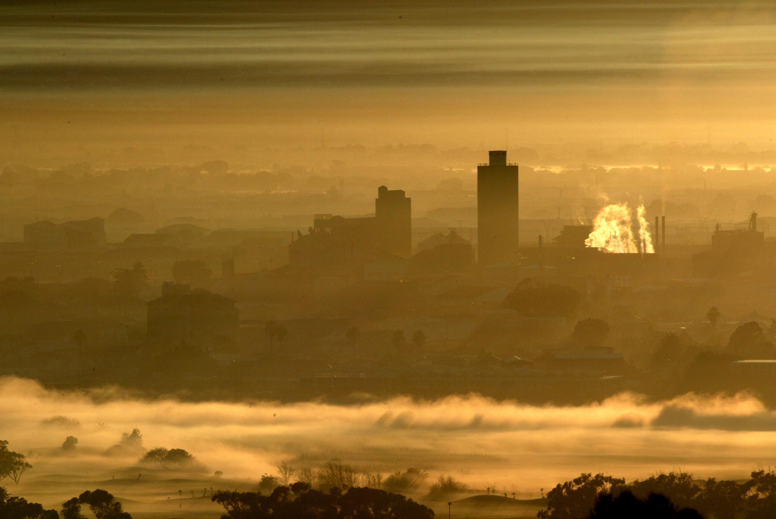 Early morning smog hangs in the air as dawn breaks.