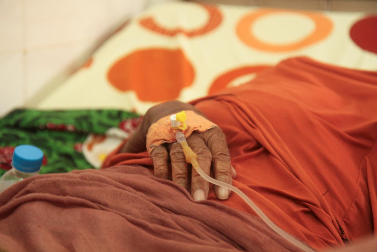 An older woman that has been hospitalized for dehydration during the recent record heat wave receives and IV drip at hospital.