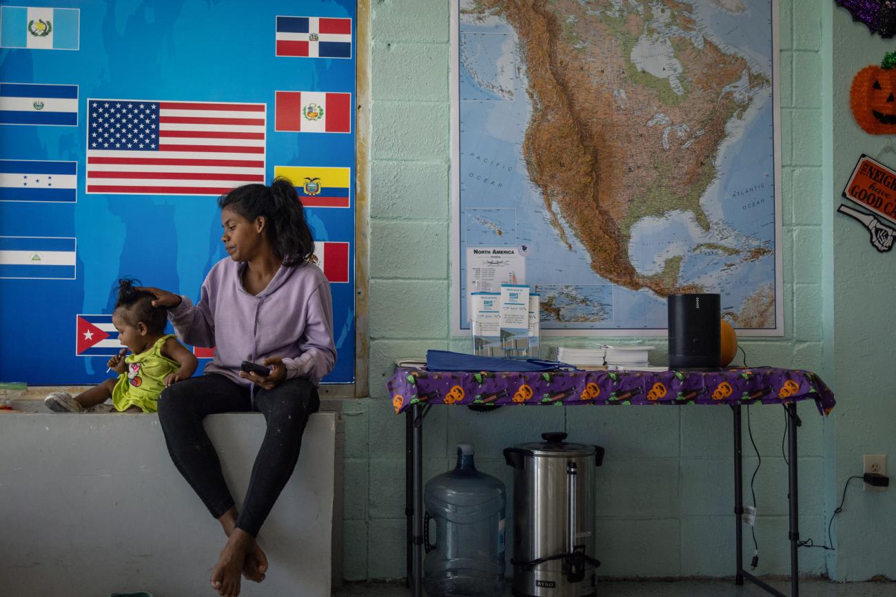 Venezuelan asylum seeker, Maria Angel, comforts her daughter Arianna at a welcoming center for migrants.