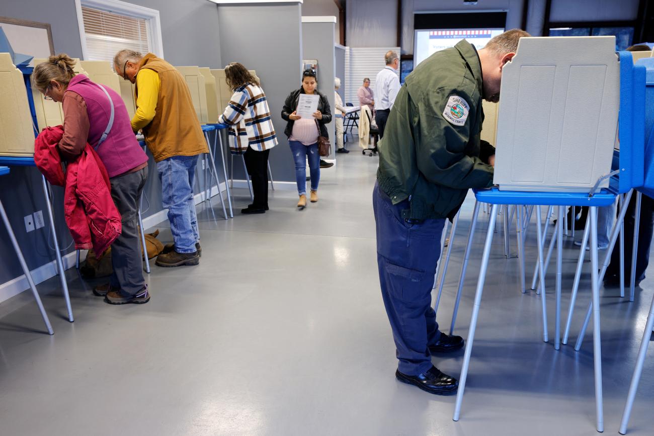 Voters mark their ballots on the first day of early in-person voting in one of the mountainous counties badly affected by Hurricane Helene.
