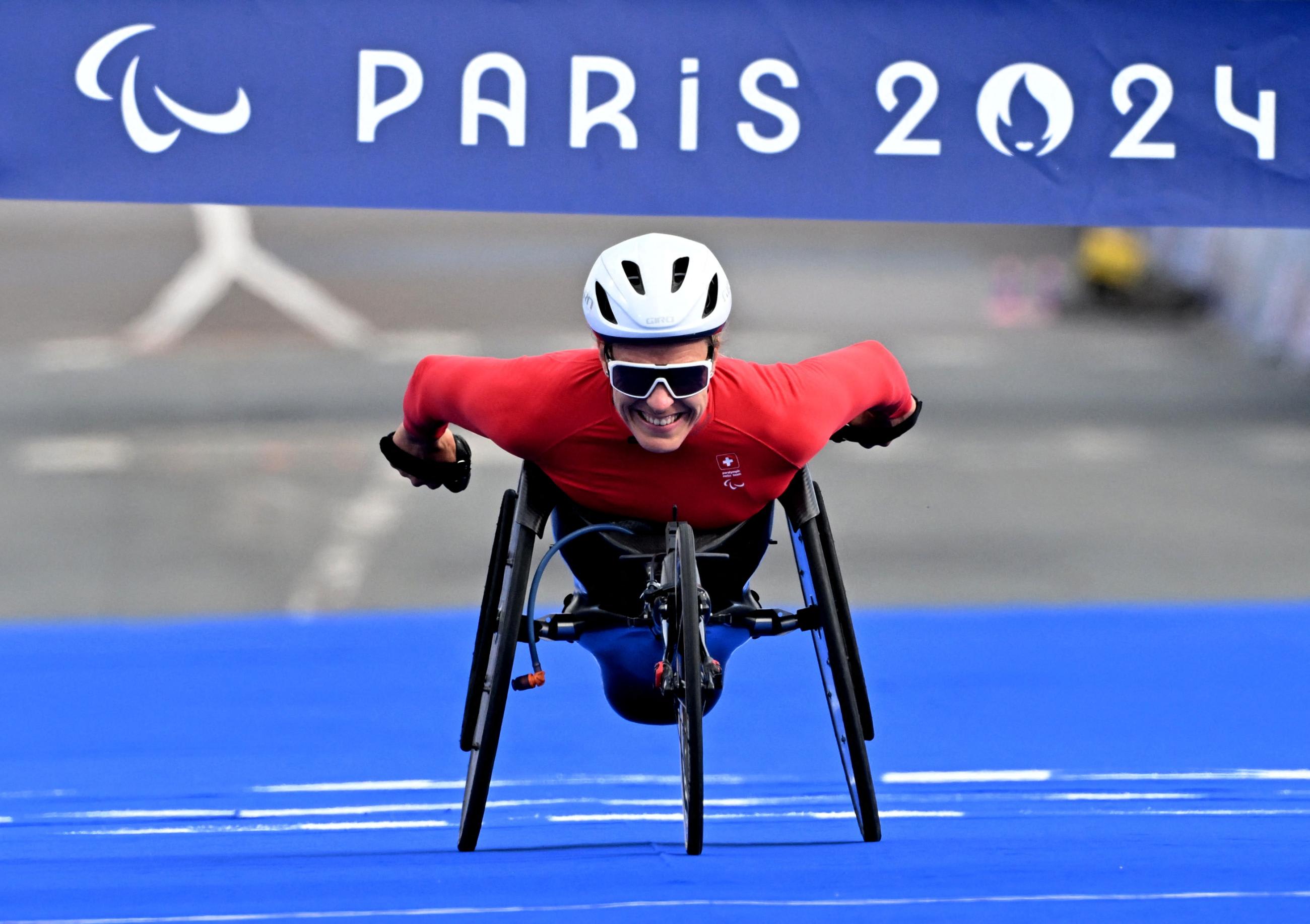 Catherine Debrunner of Switzerland crosses the finish line in first place to win gold at the Paris 2024 Paralympics.